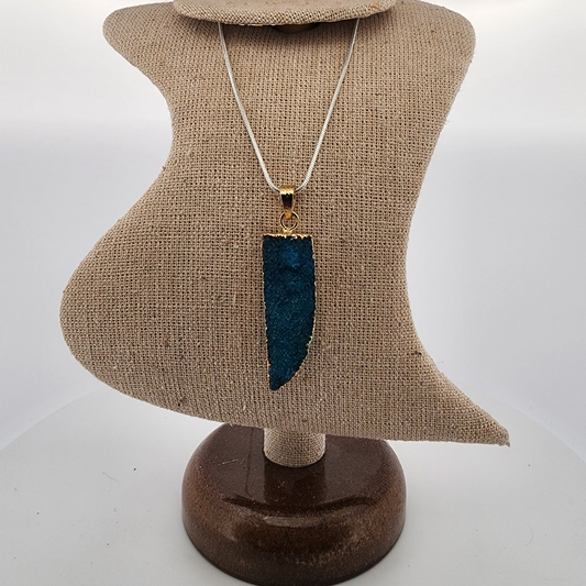 Necklace with a blue pendant on a mannequin bust against a white background