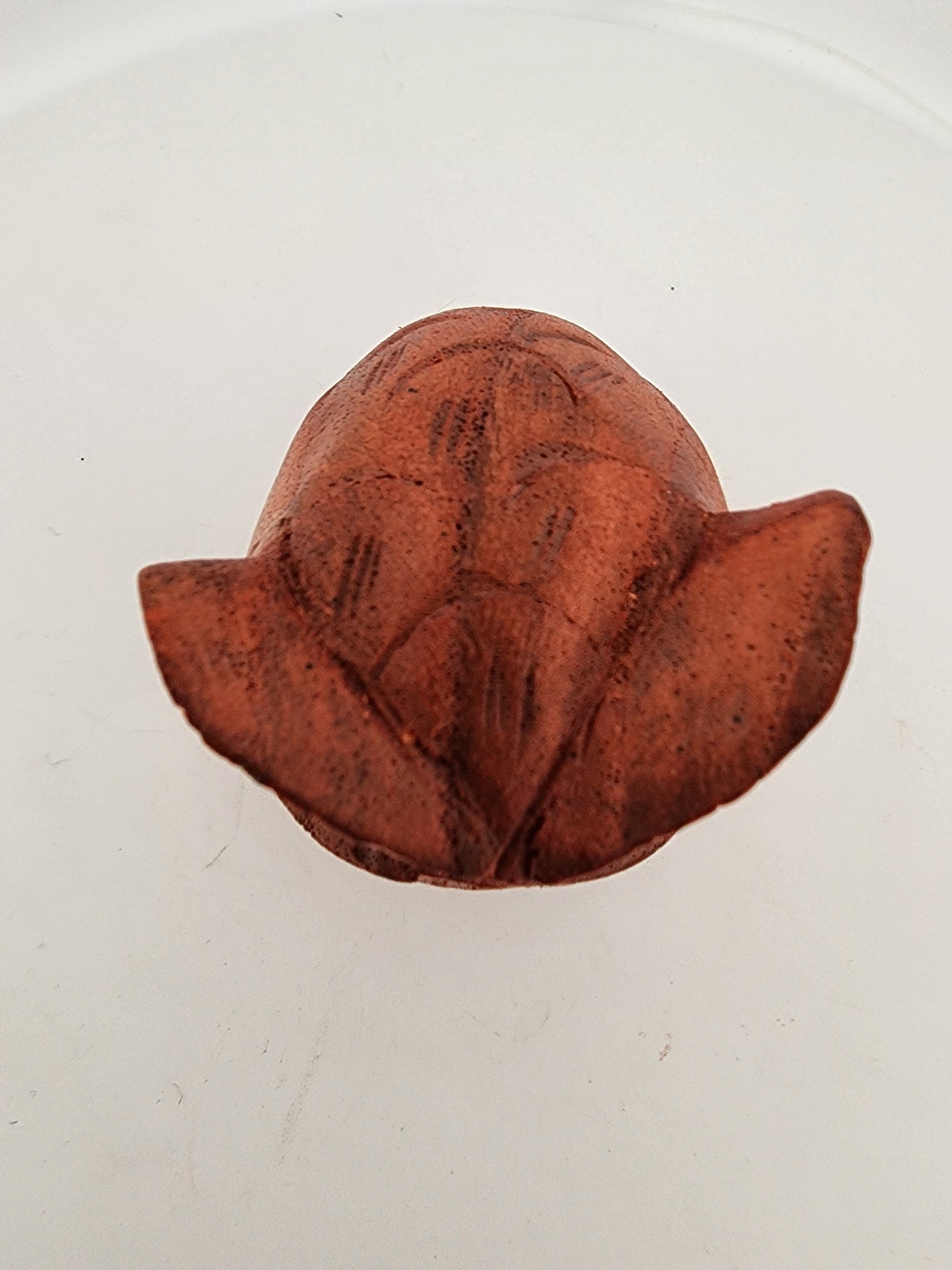 Brown clay flower on a white background