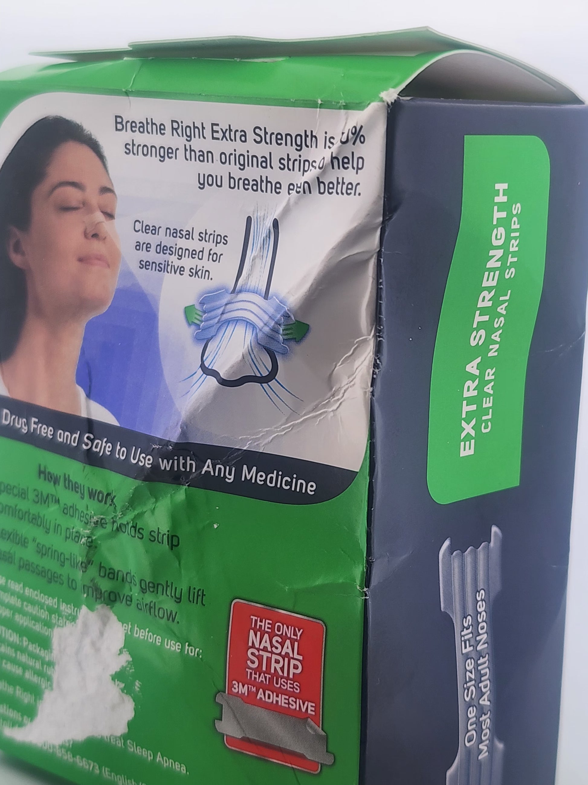Box of Breathe Right Extra Strength nasal strips with a woman using the product on a white background.