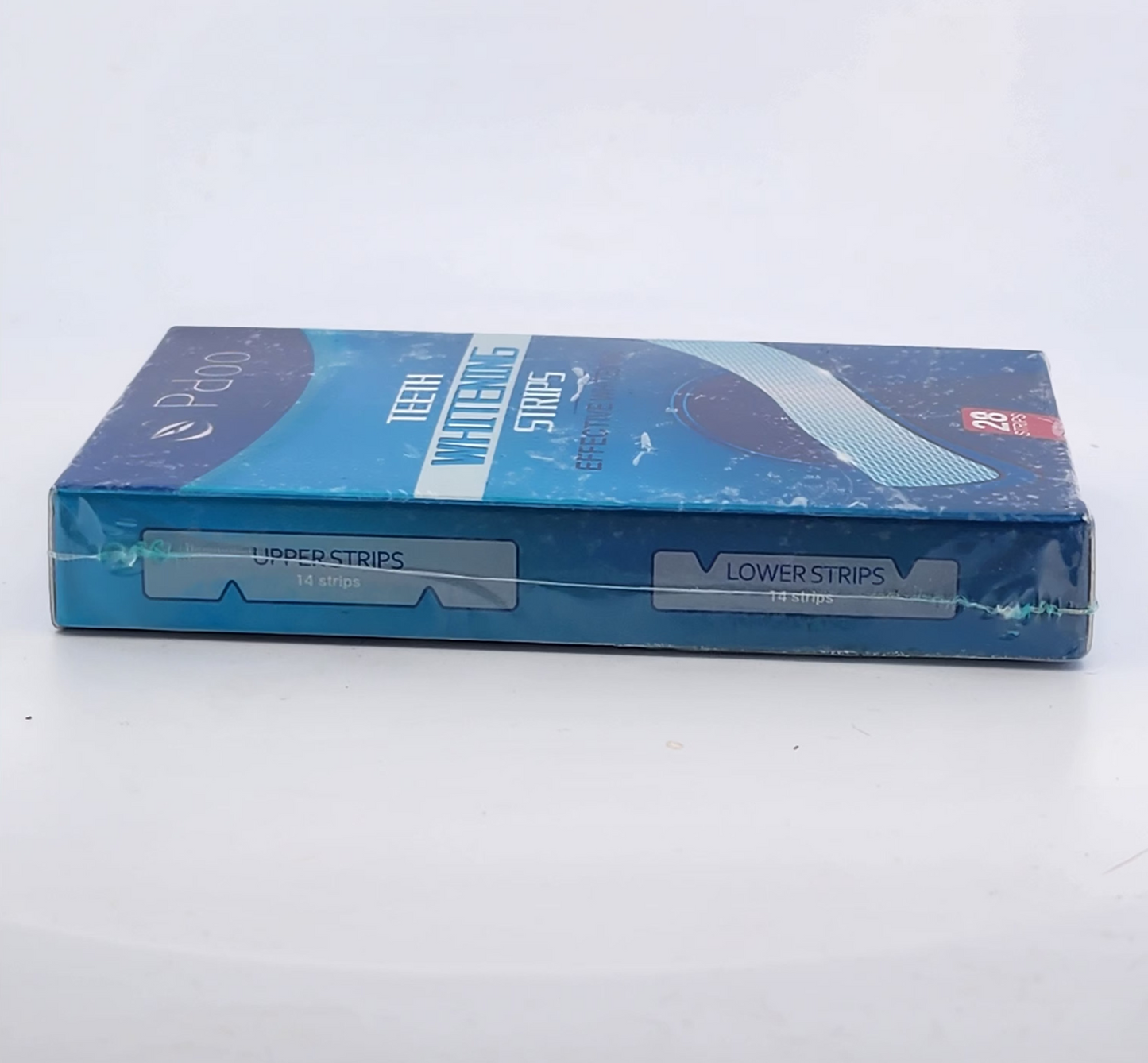 Blue packaging of dental strips on a white surface
