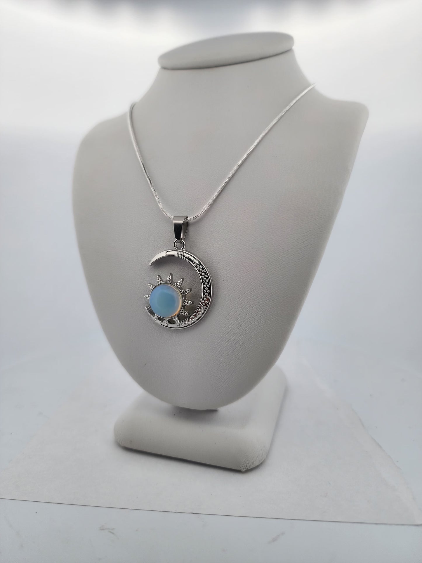 Necklace with a pendant on a mannequin bust against a white background