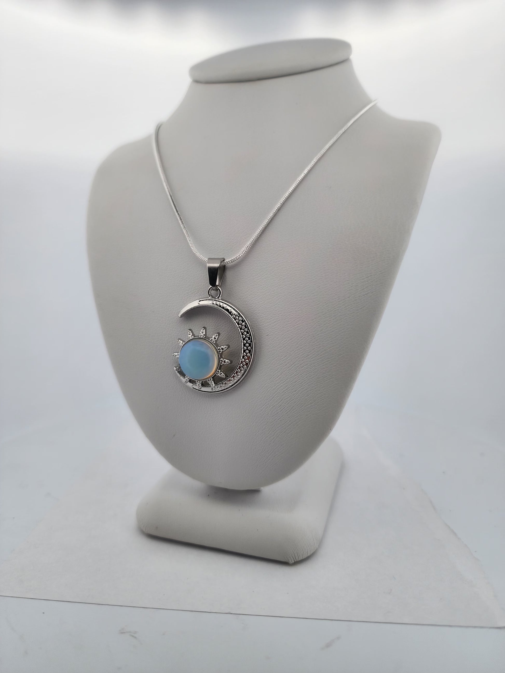 Necklace with a pendant on a mannequin bust against a white background