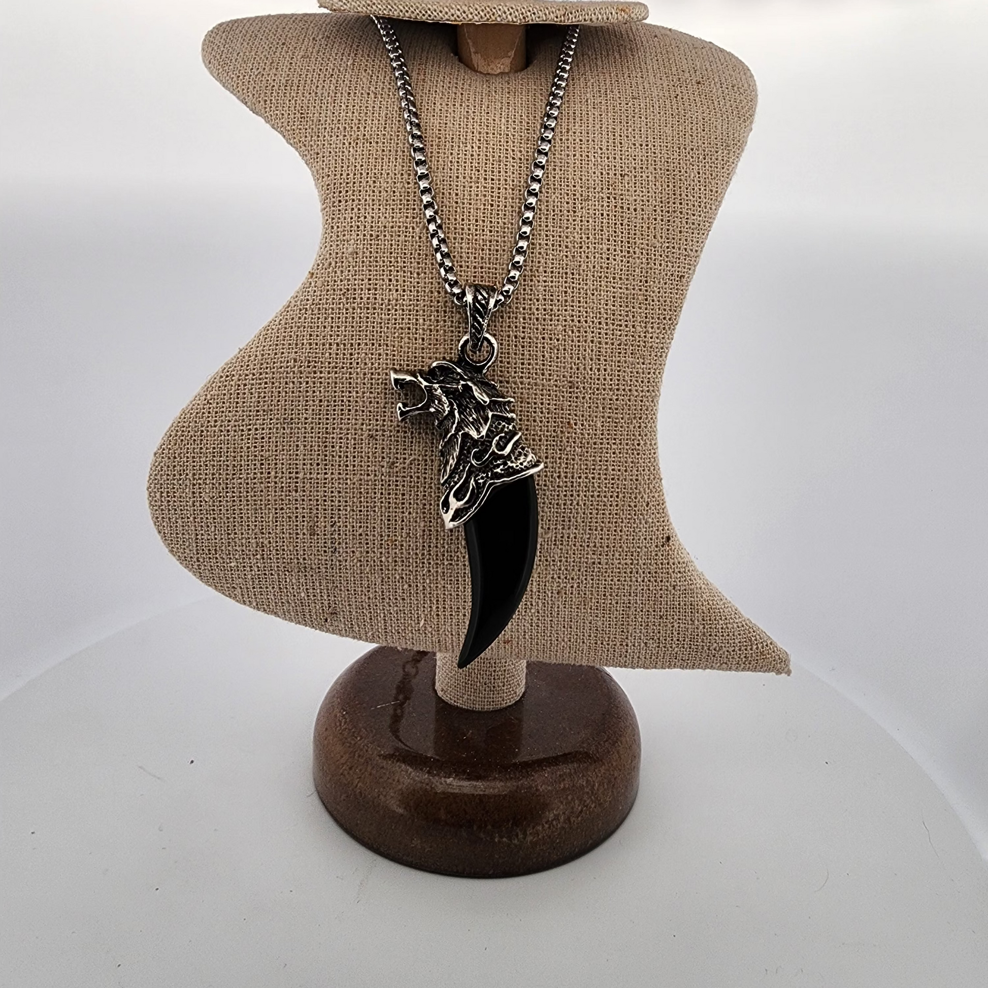 Necklace with a pendant on a mannequin bust against a white background