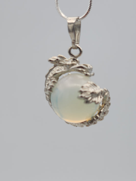 Jewelry with a central gemstone and silver accents on a gray background