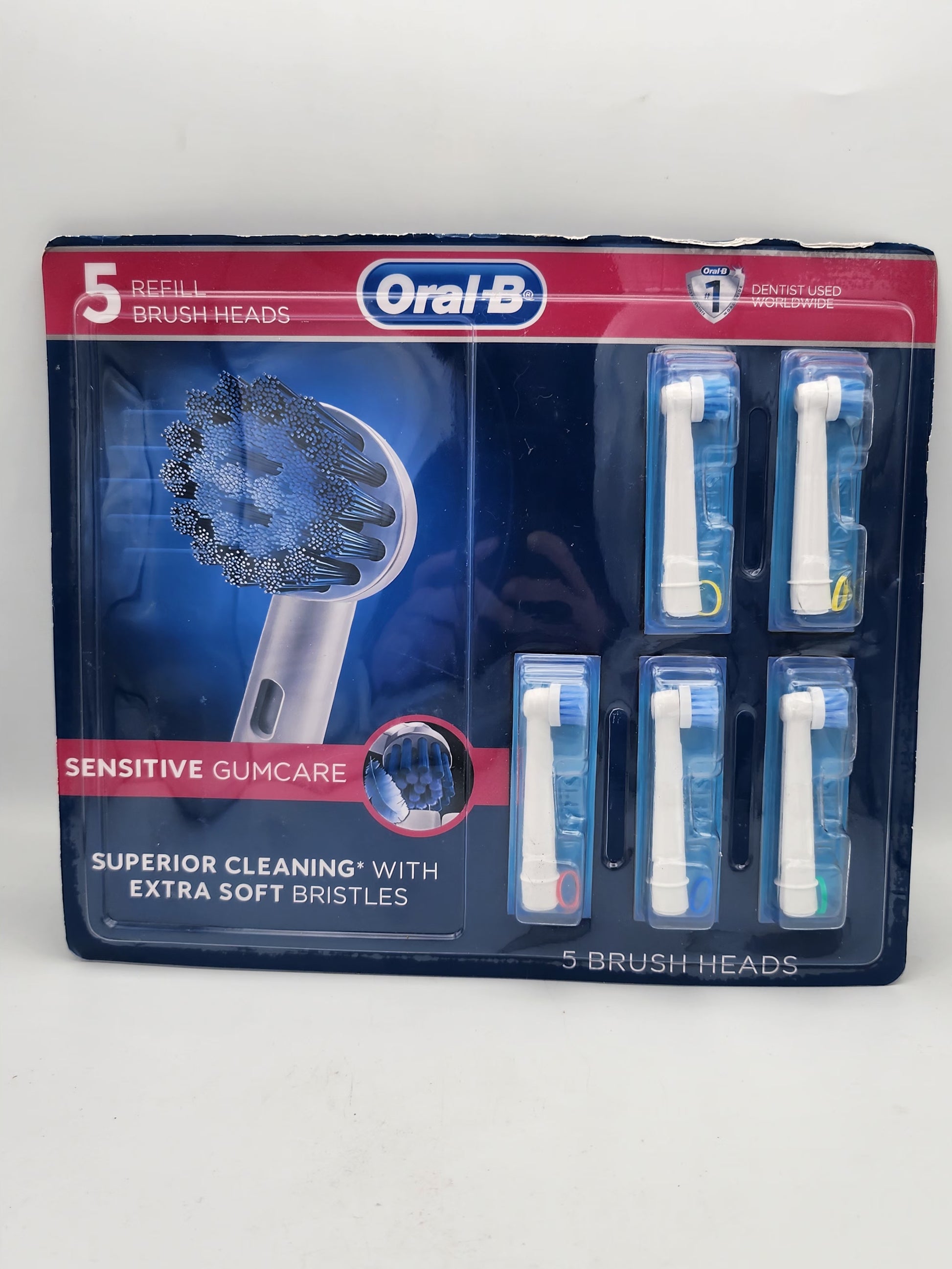 Packaging of Orajel dental care product with brush heads on a white background