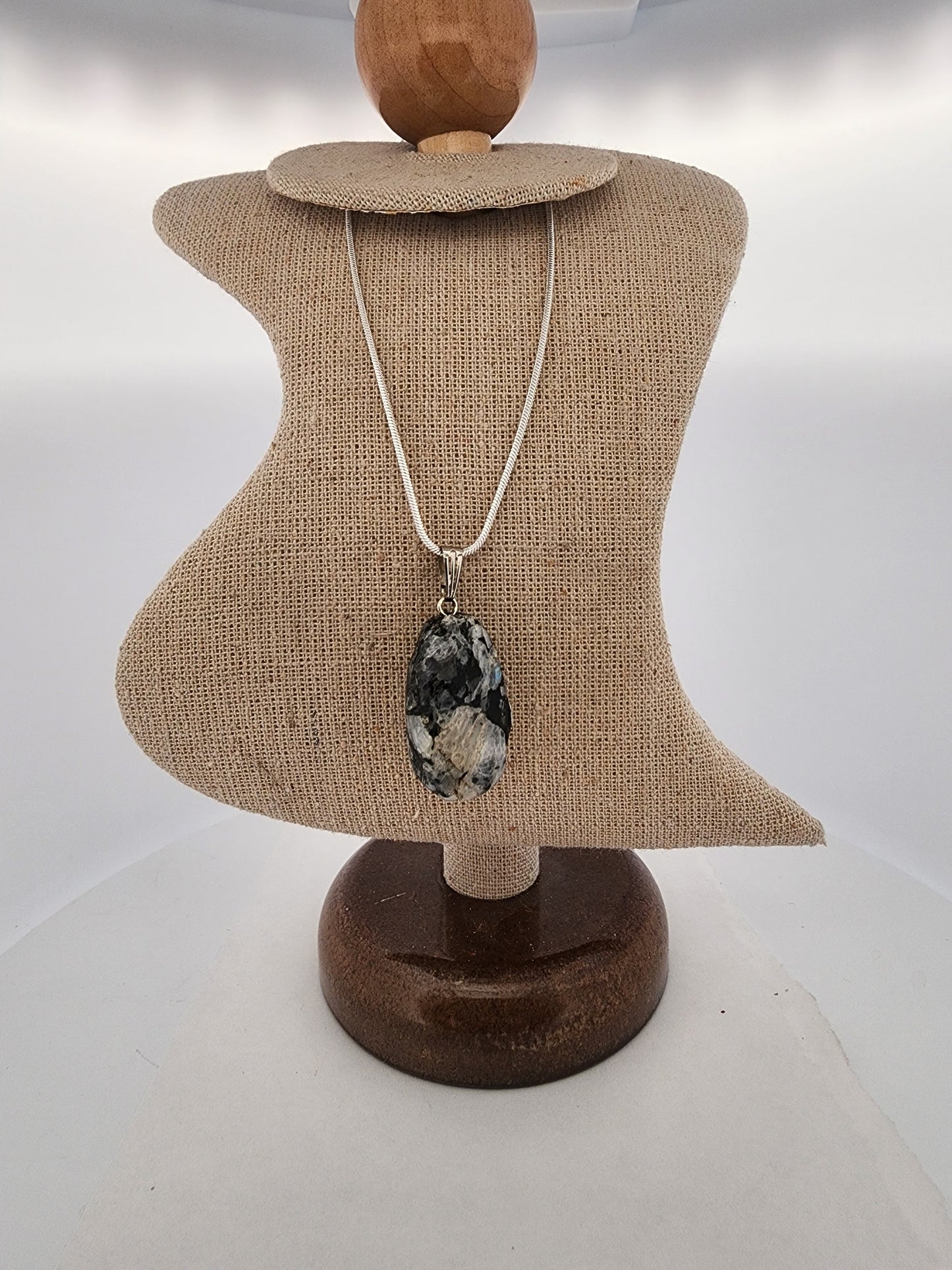 Necklace with a pendant on a mannequin bust against a white background