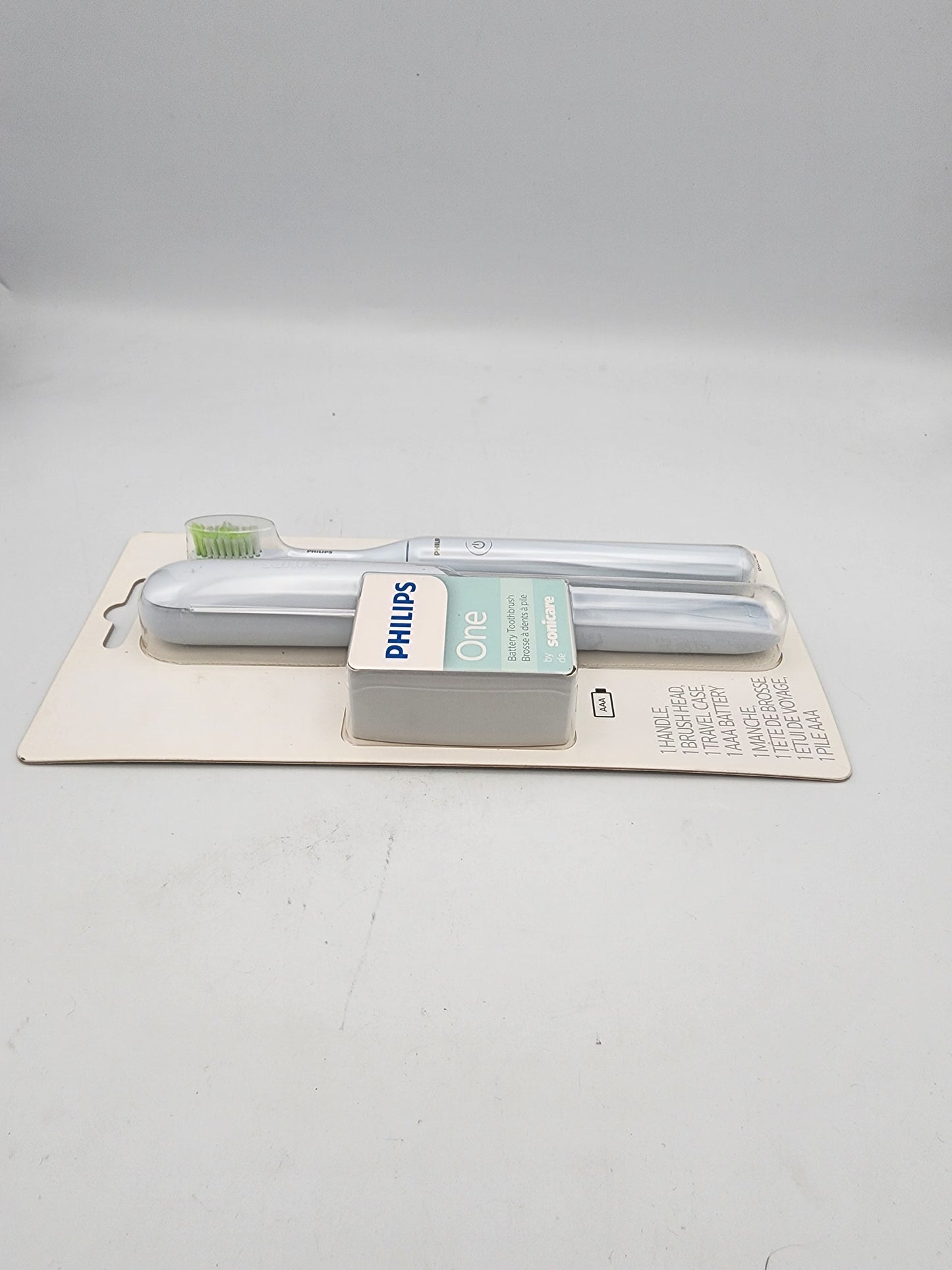 Two Philips light bulbs in packaging on a gray background