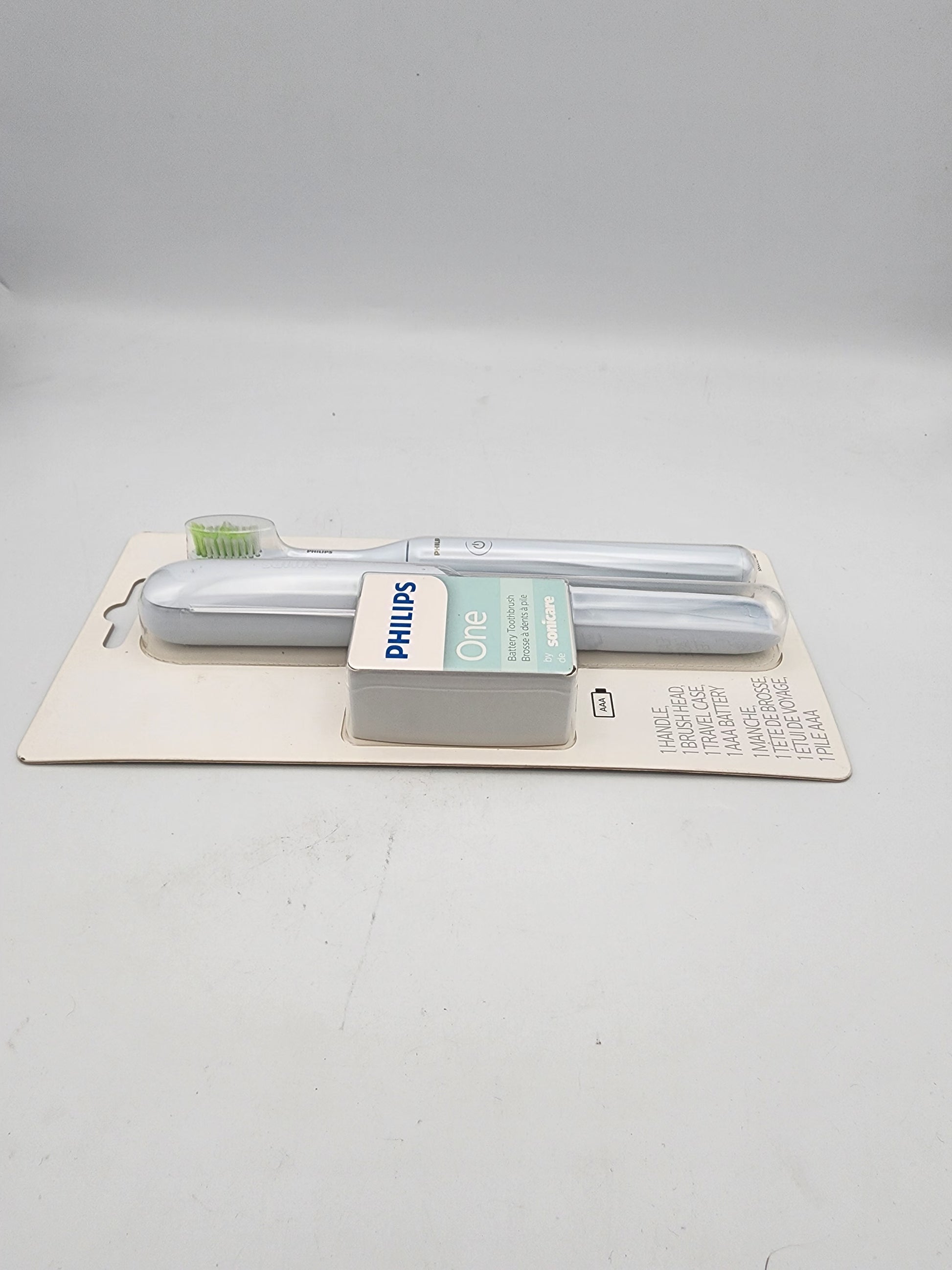 Two Philips light bulbs in packaging on a gray background