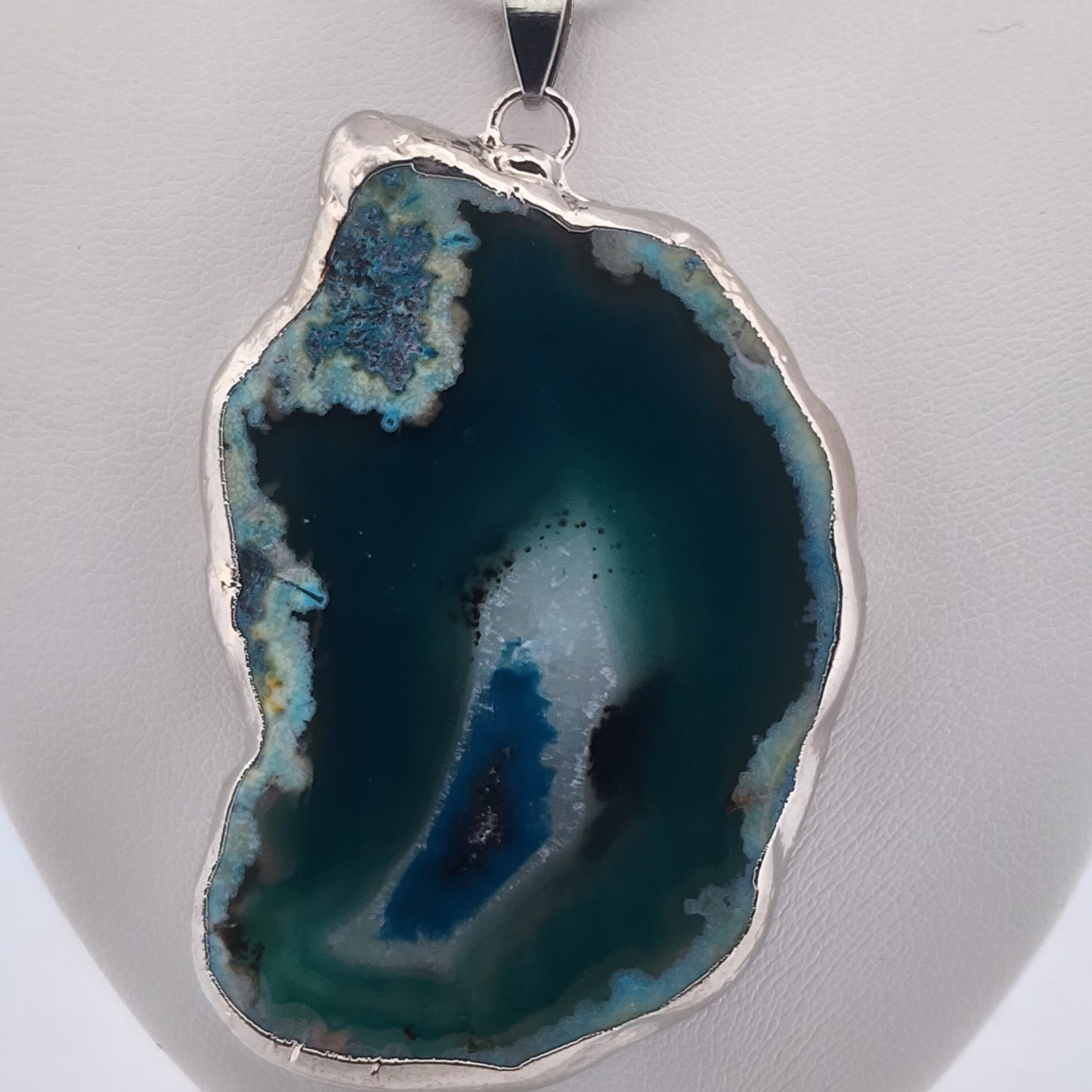 Agate pendant with silver setting on a white background