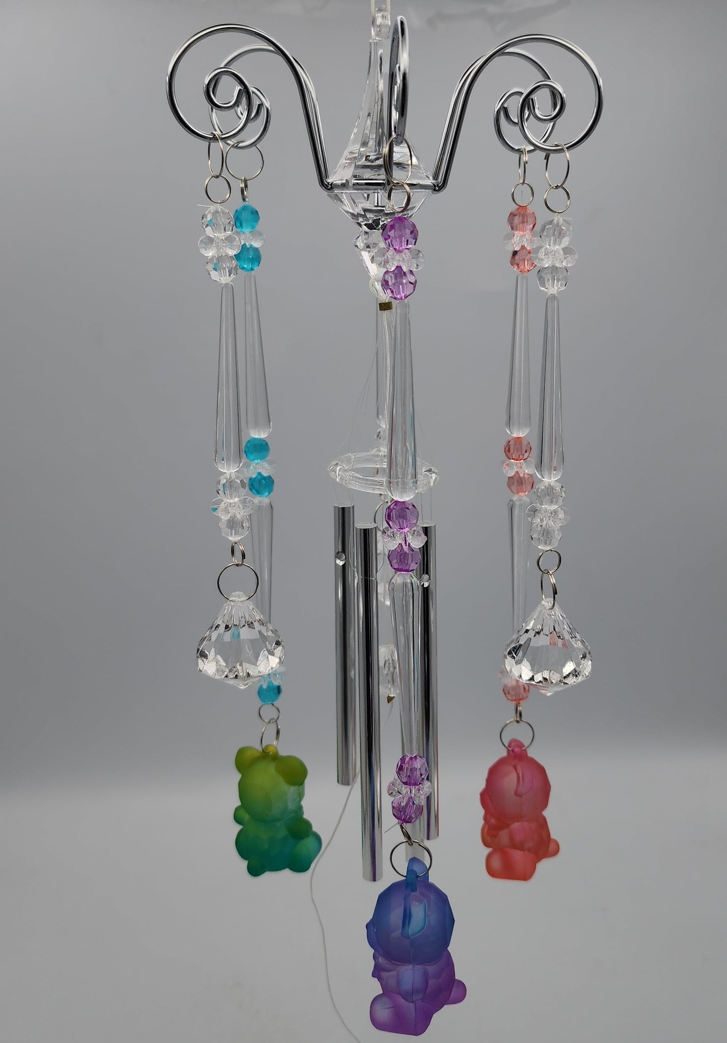 Decorative hanging with colorful beads on a plain background