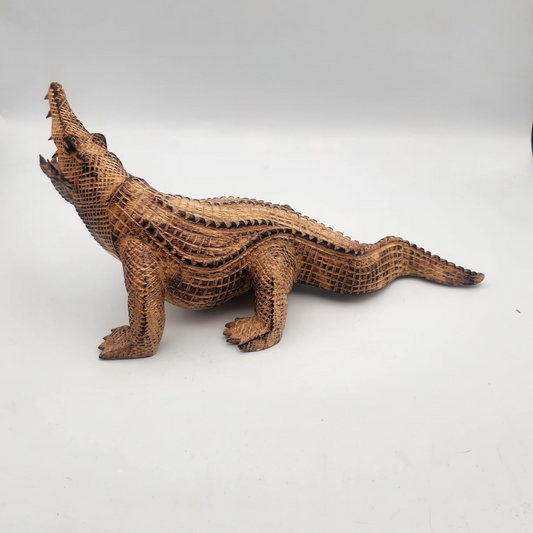 Brown crocodile figurine on a white background