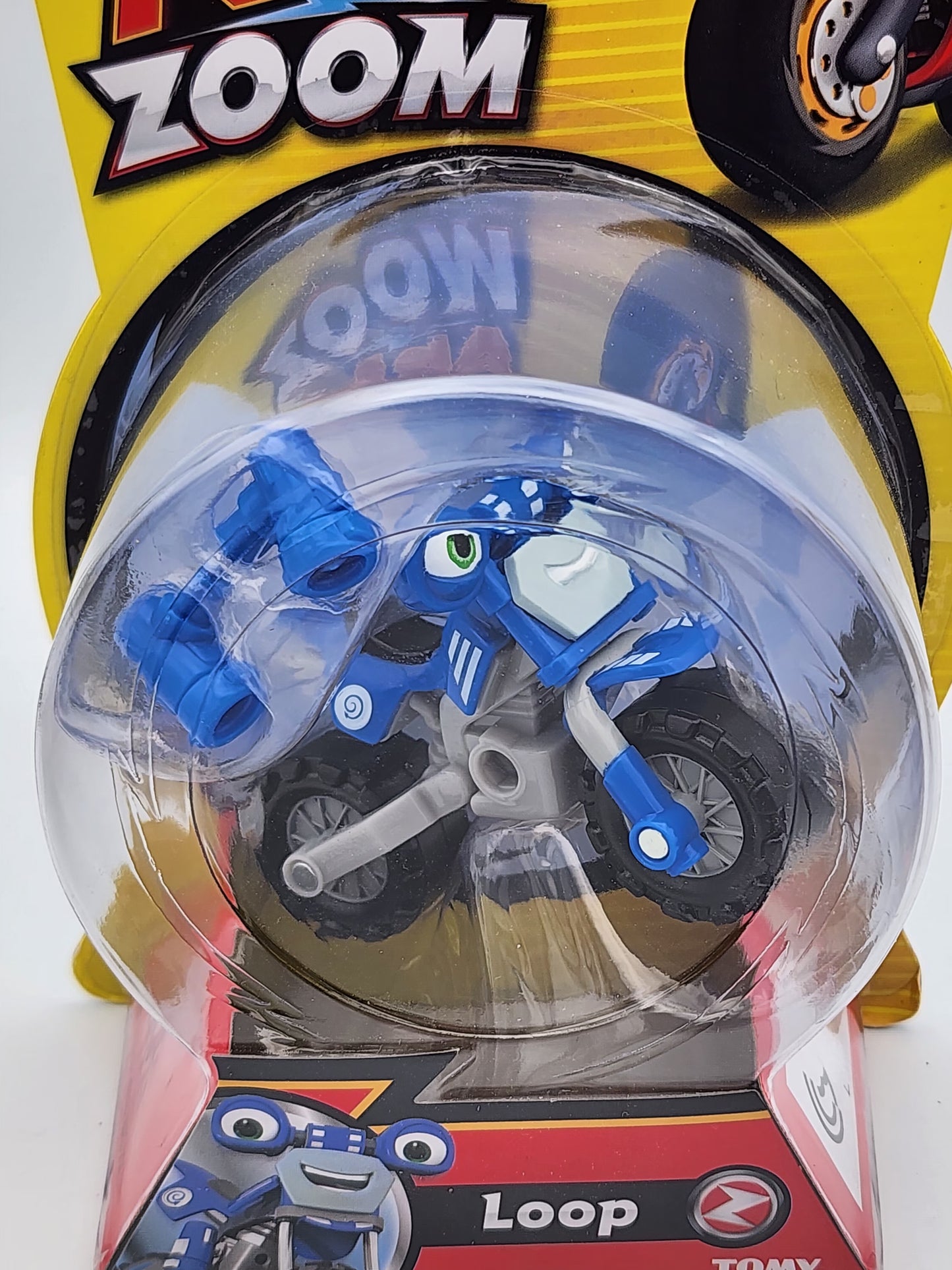 Toy motorcycle in packaging with 'Zoom' branding