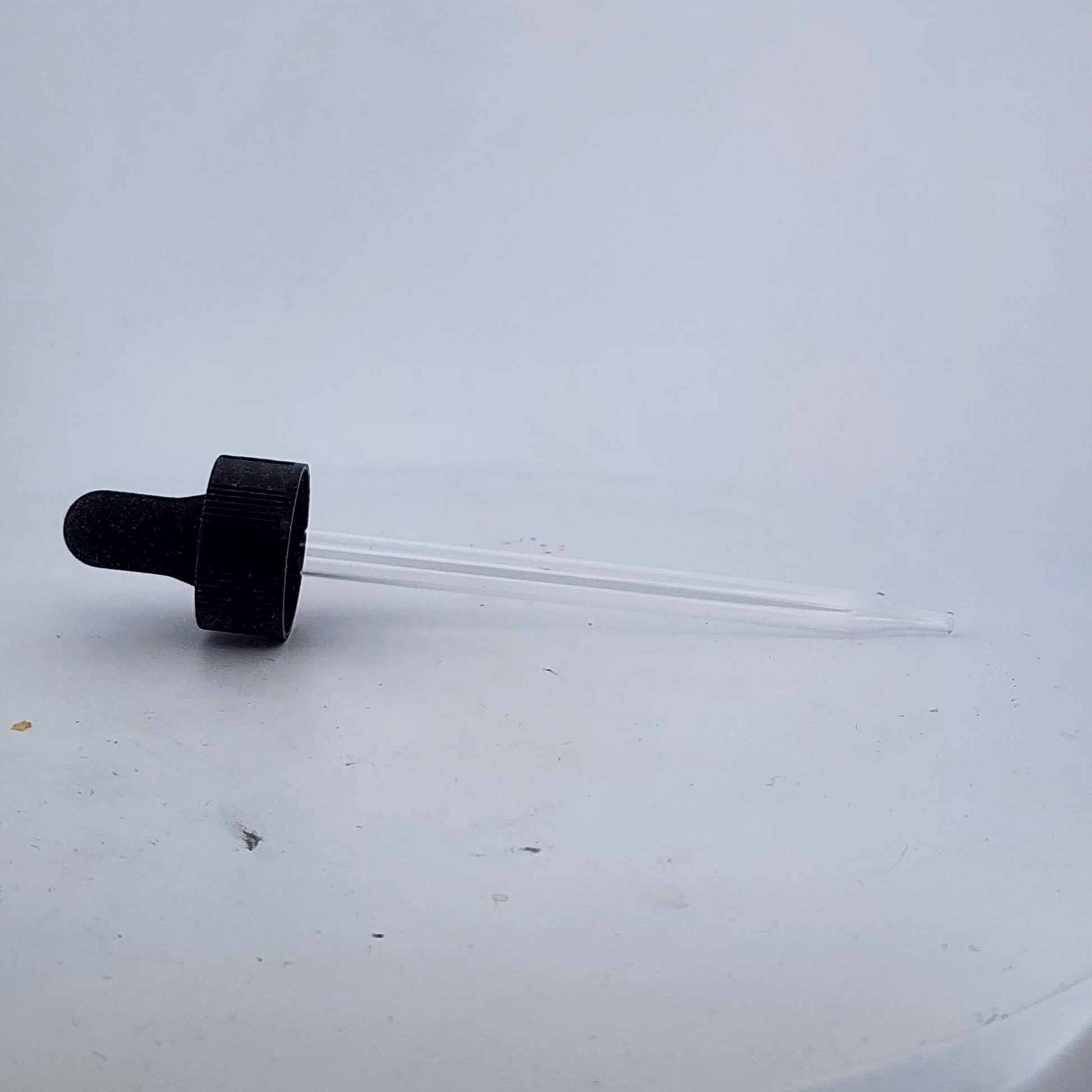 Black cap with a clear tube on a white background