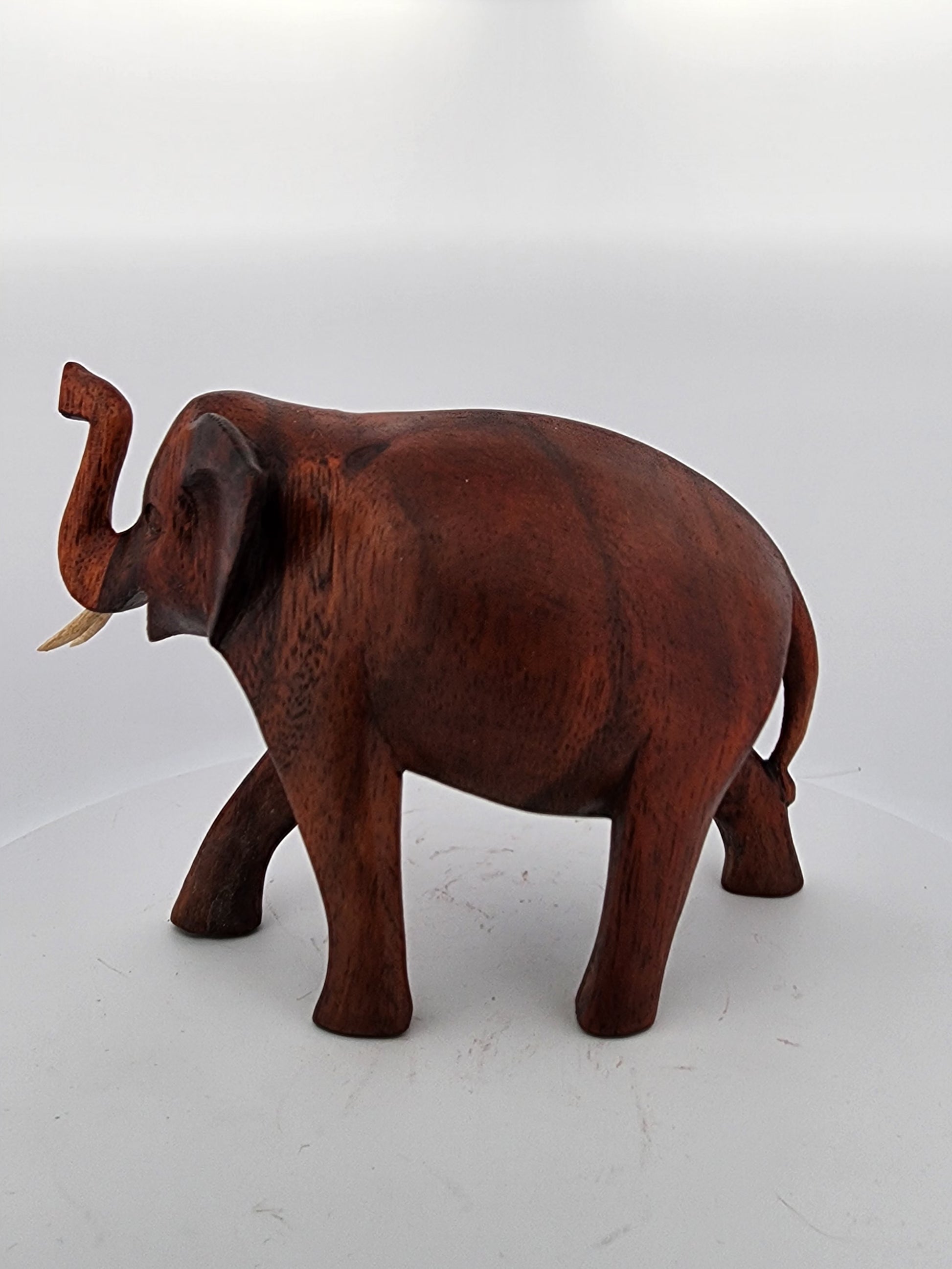 Wooden elephant figurine on a white background