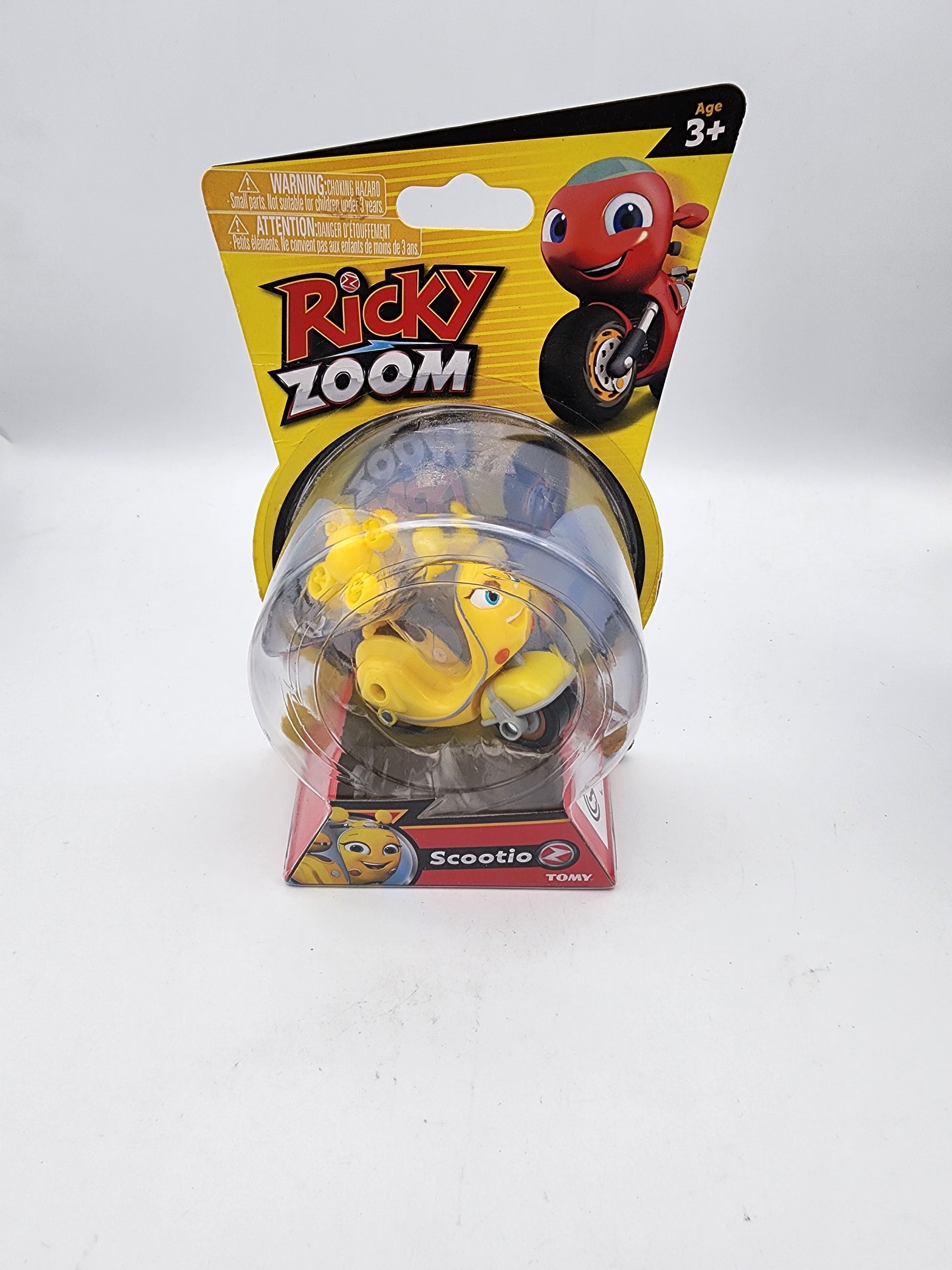 Toy figure in packaging with 'Ricky Zoom' branding on a white background