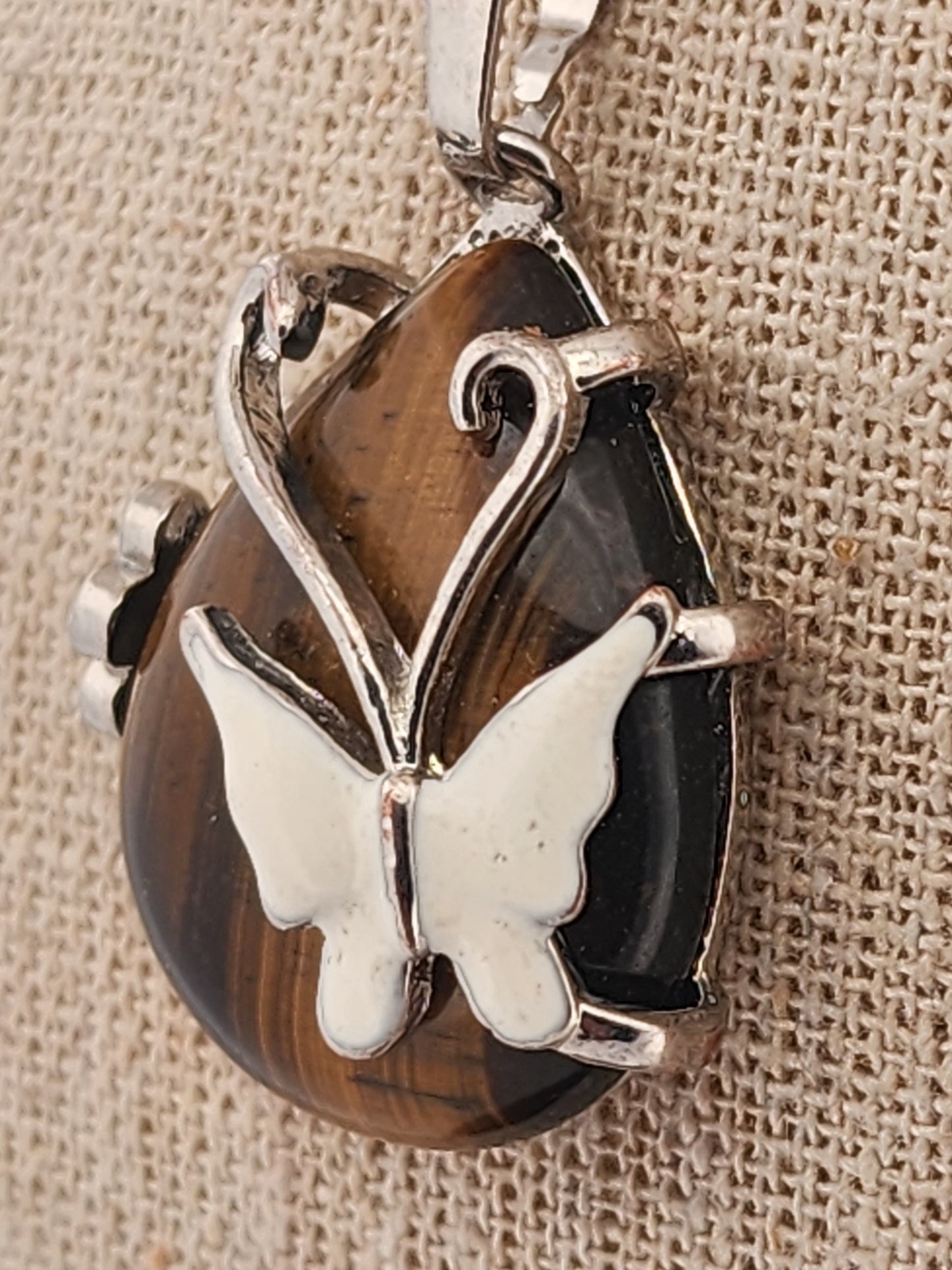 Butterfly pendant on a brown stone background