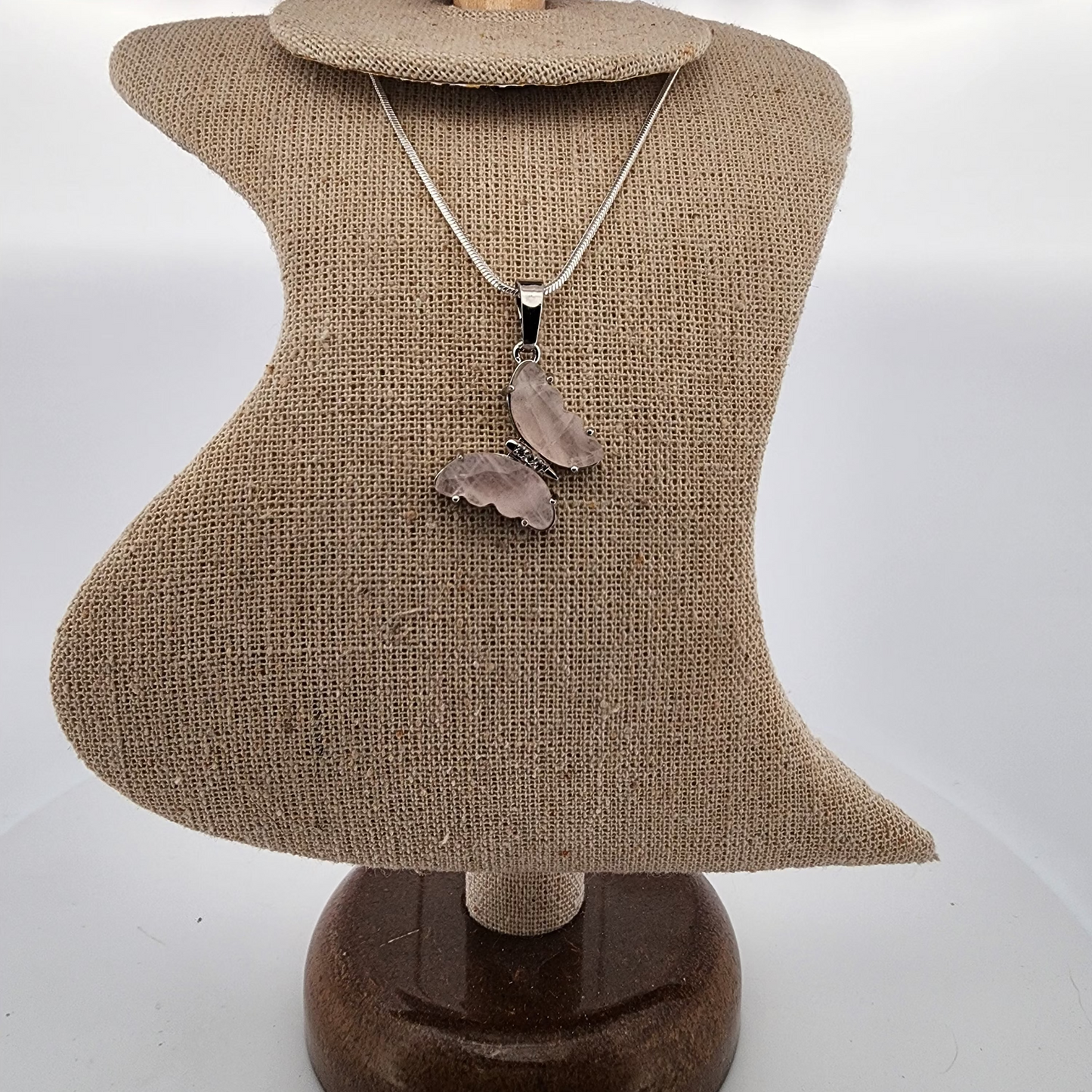 Necklace with a pendant on a mannequin bust against a white background
