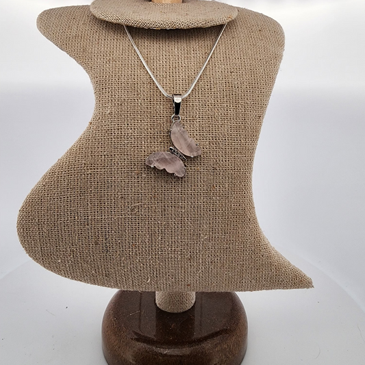 Necklace with a pendant on a mannequin bust against a white background
