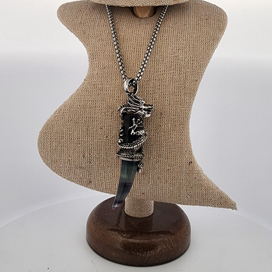 Necklace with a pendant on a mannequin bust against a plain background
