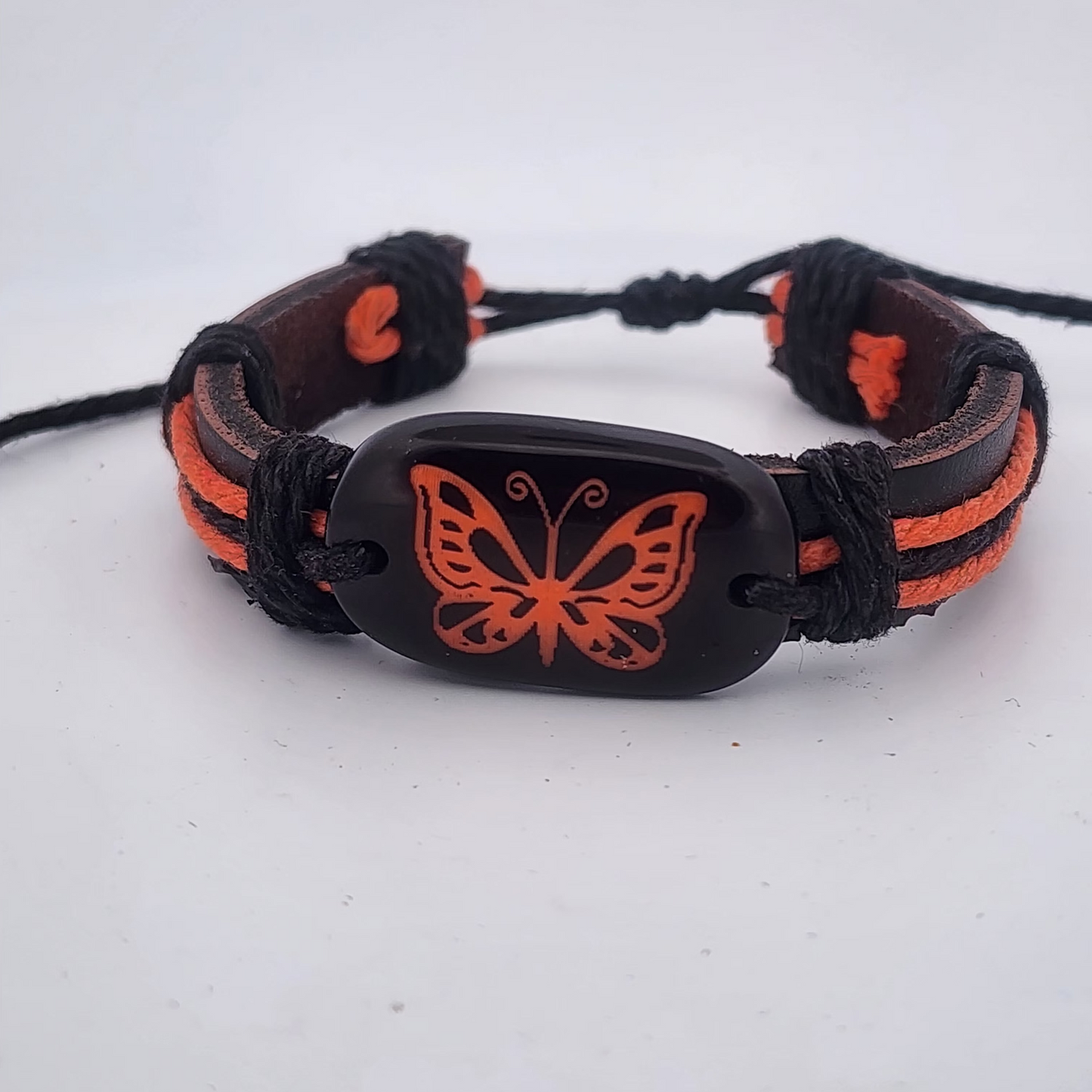 Bracelet with orange butterfly design on a white background