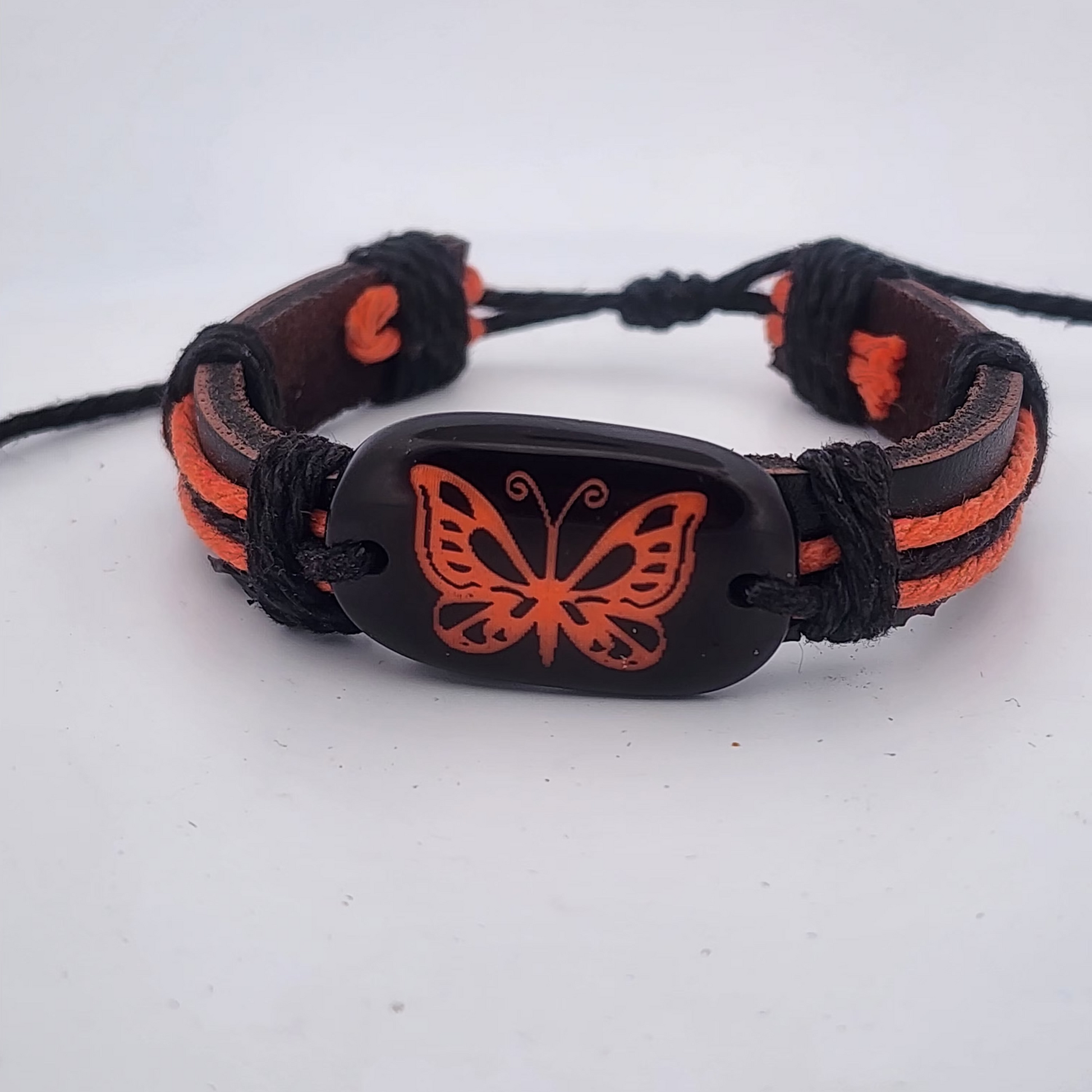 Bracelet with orange butterfly design on a white background