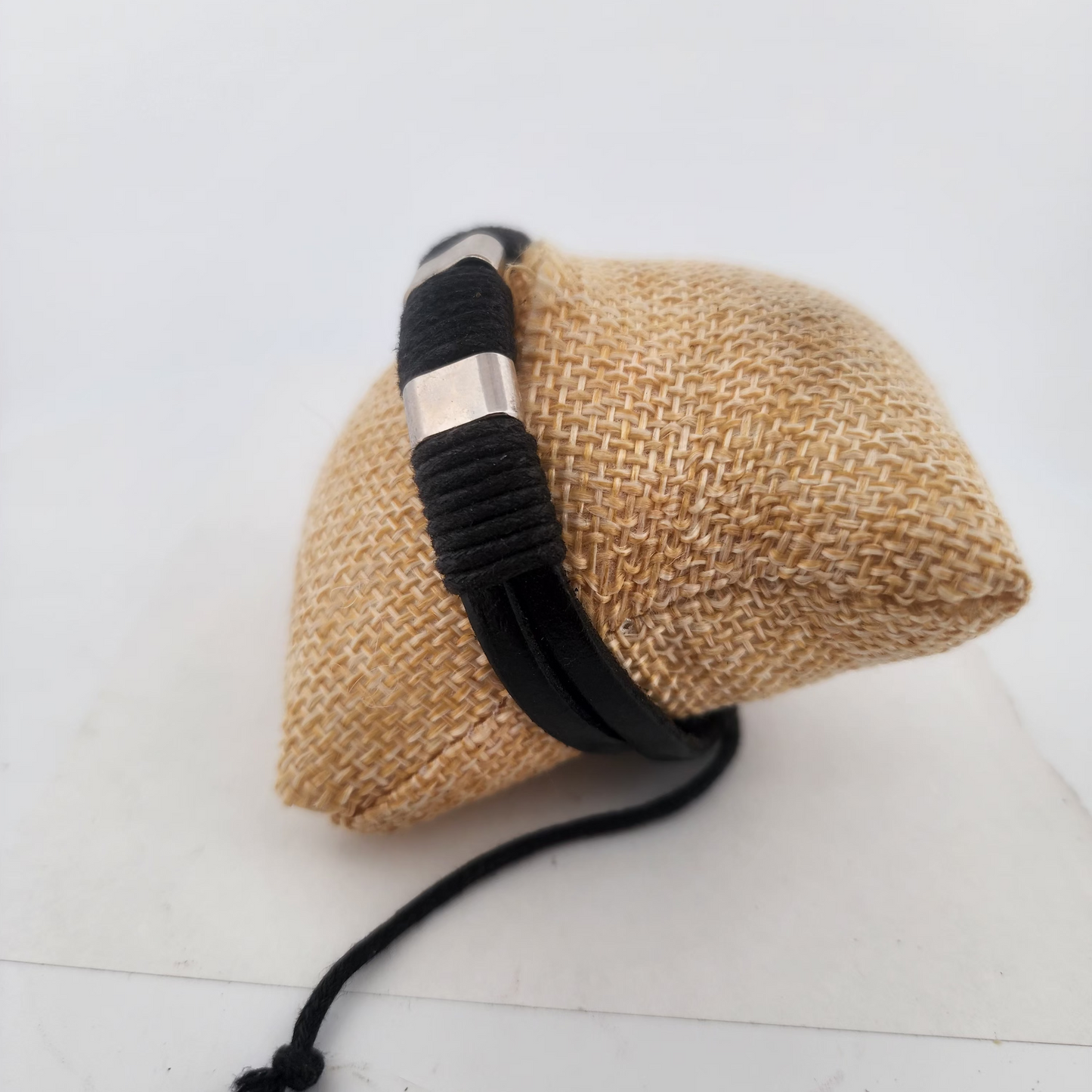 Bracelet on a textured beige pillow against a white background