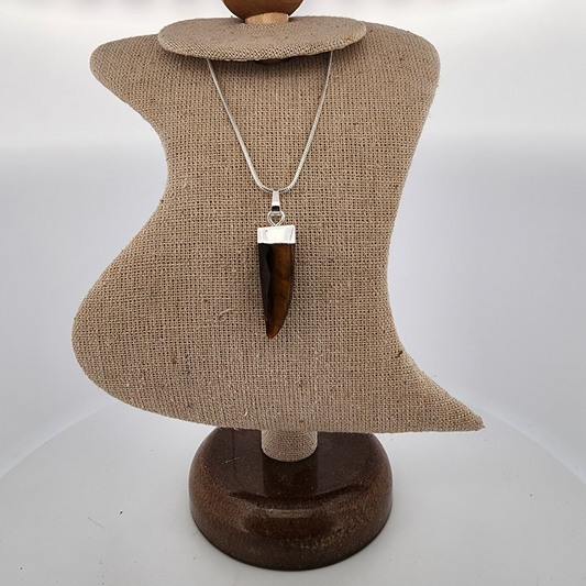 Jewelry display with a necklace on a mannequin bust against a white background