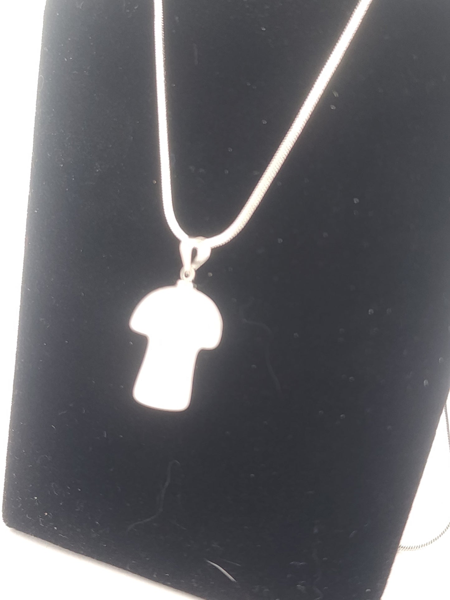 Necklace with a Mushroom-shaped pendant on a black background