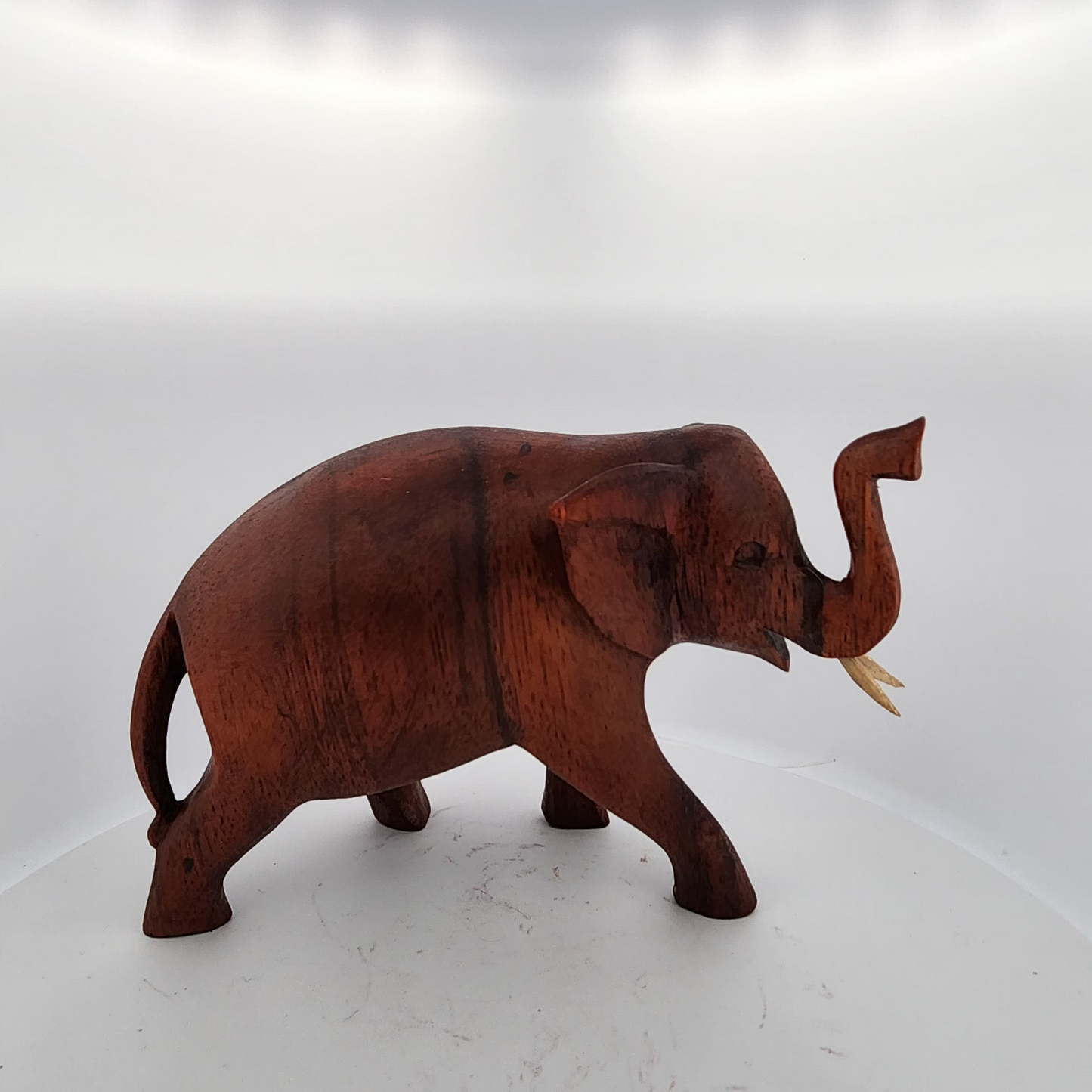 Wooden elephant figurine on a white background