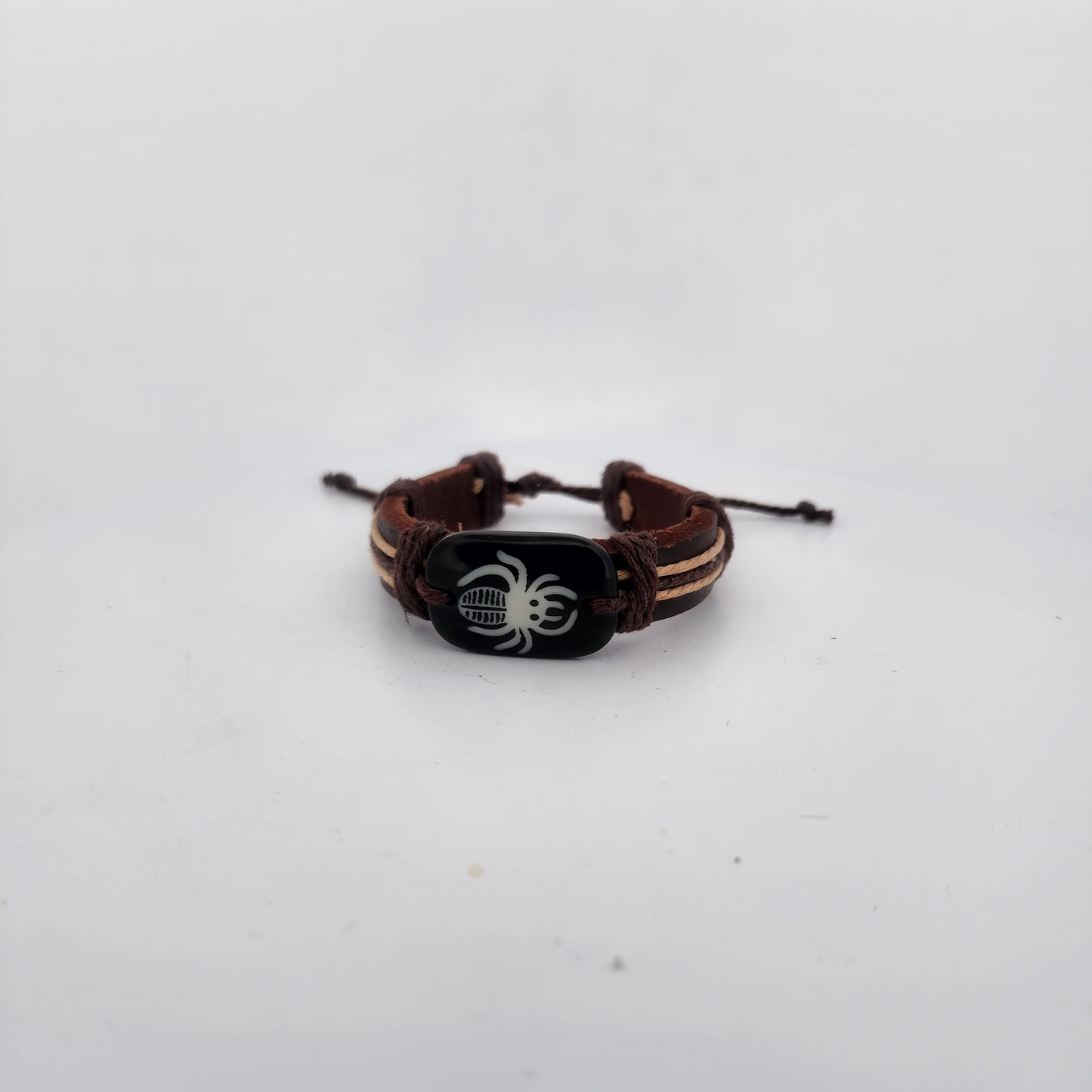 Bracelet with spider design on a white surface