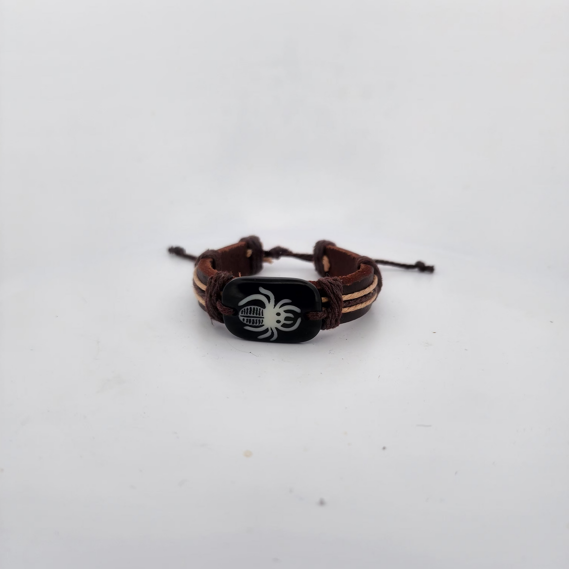Bracelet with spider design on a white surface