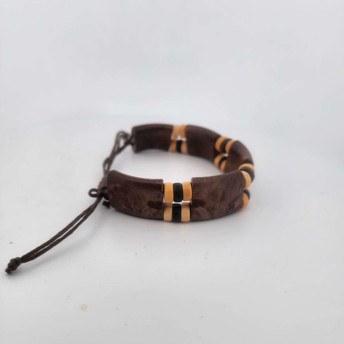 Bracelet with brown and gold beads on a white background