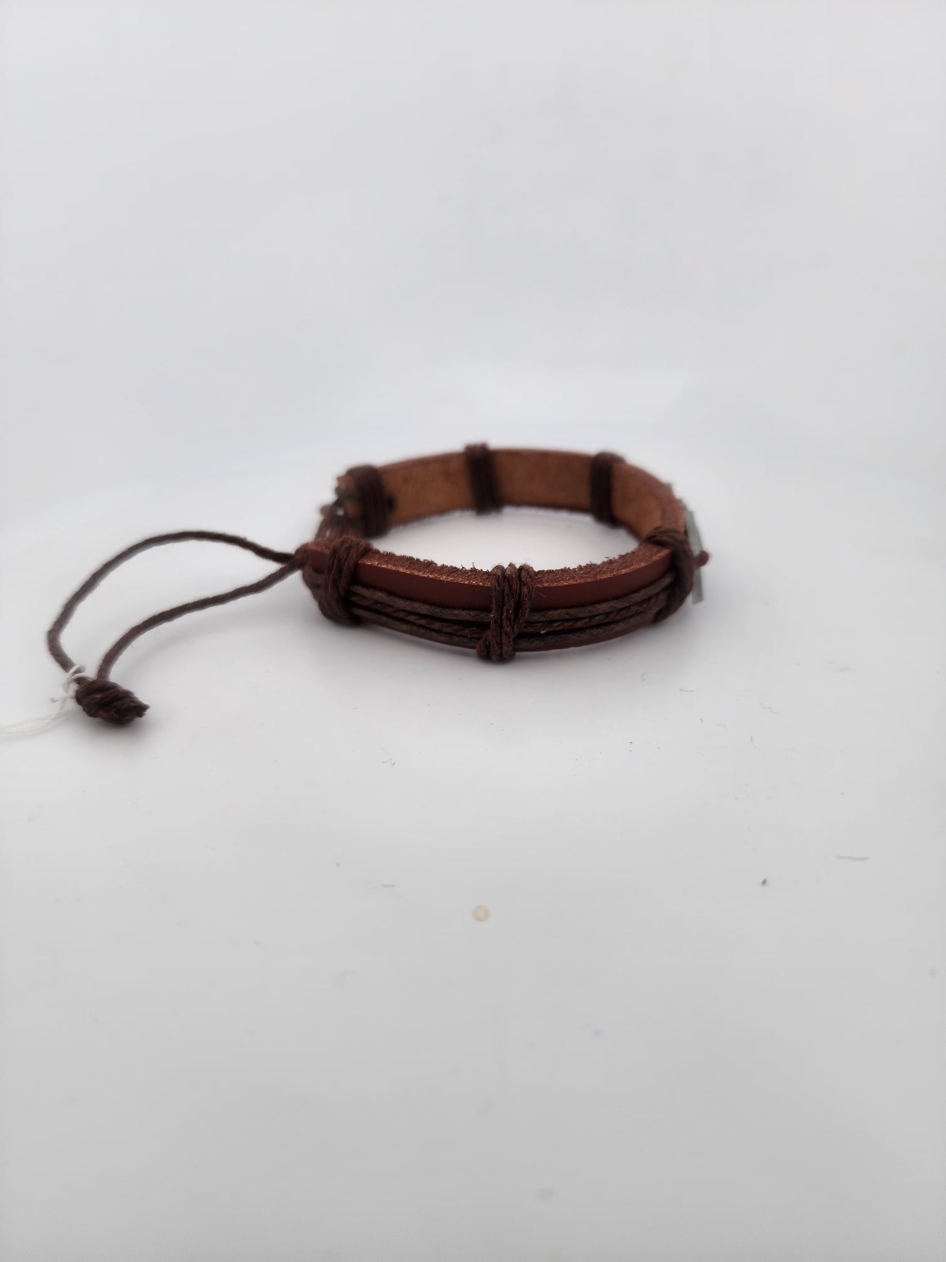 Brown braided bracelet on a white background