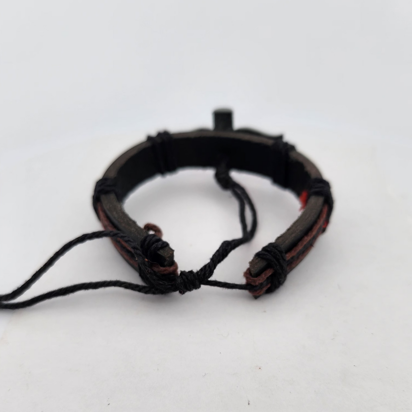 Black leather bracelet with braided design on a white background
