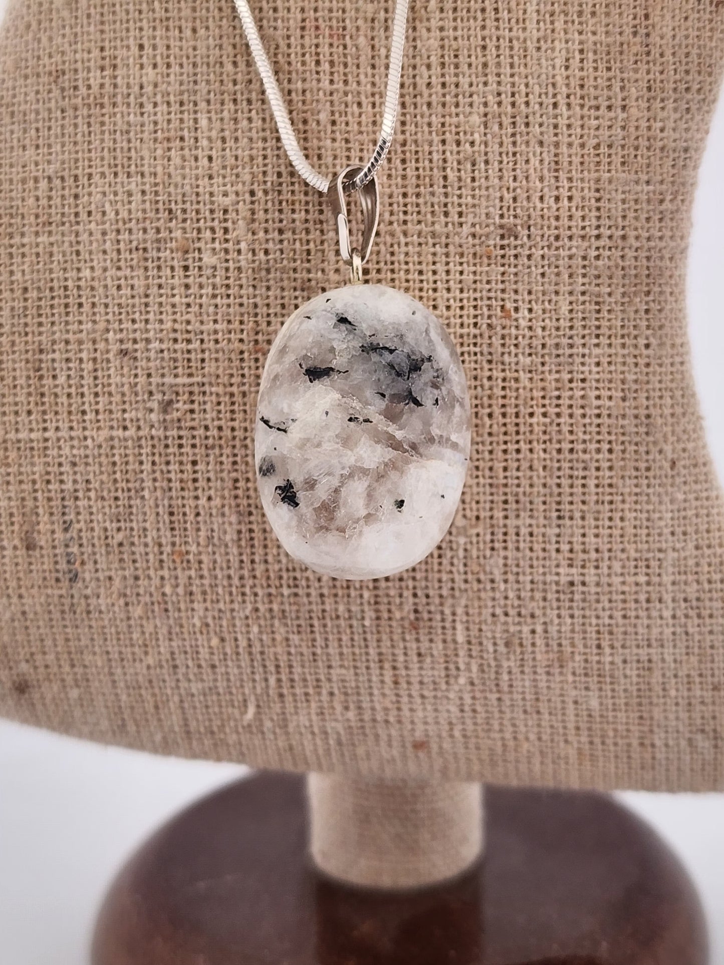 Necklace with a pendant on a mannequin bust against a white background