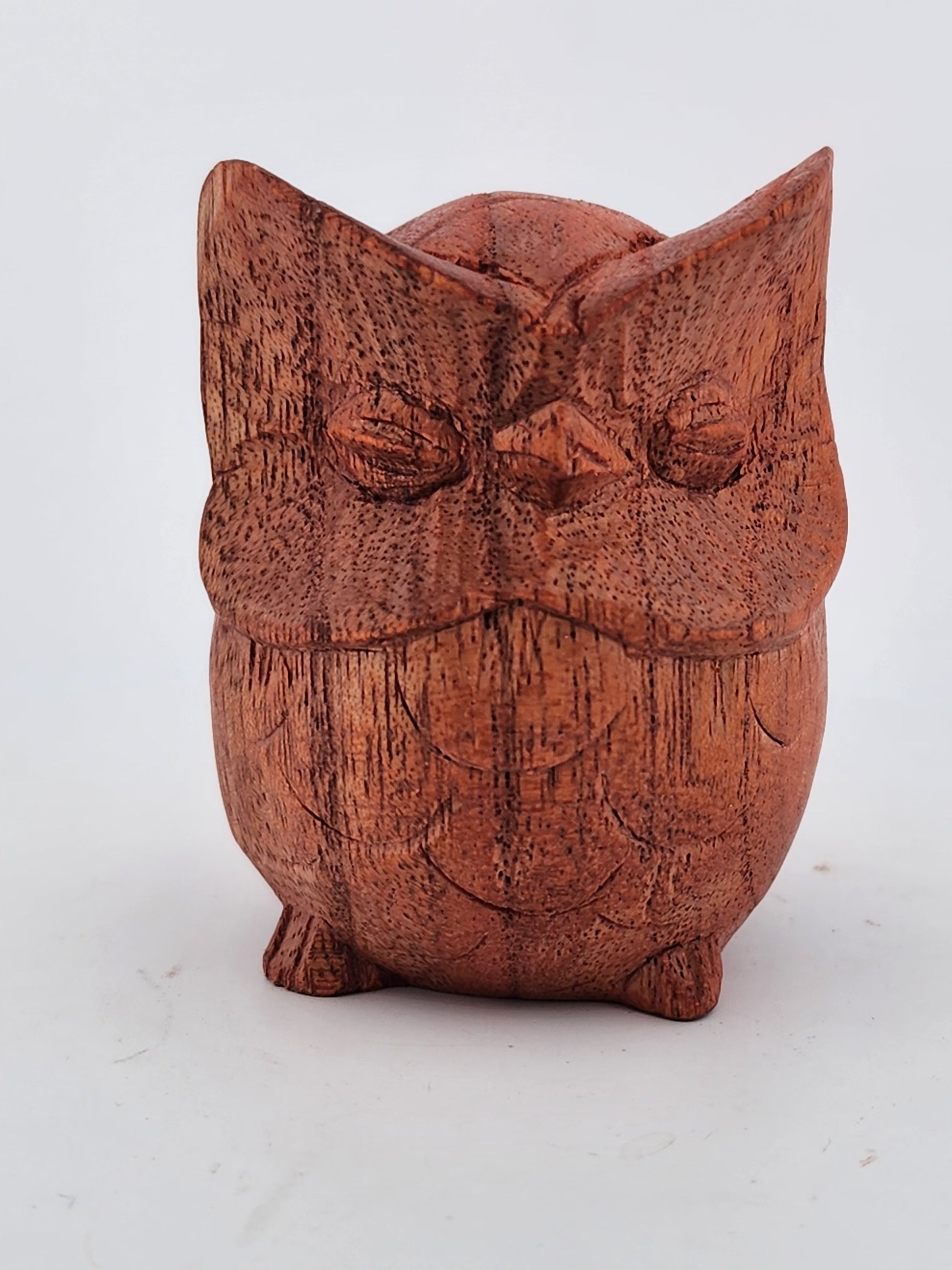 Wooden owl-shaped container on a white background