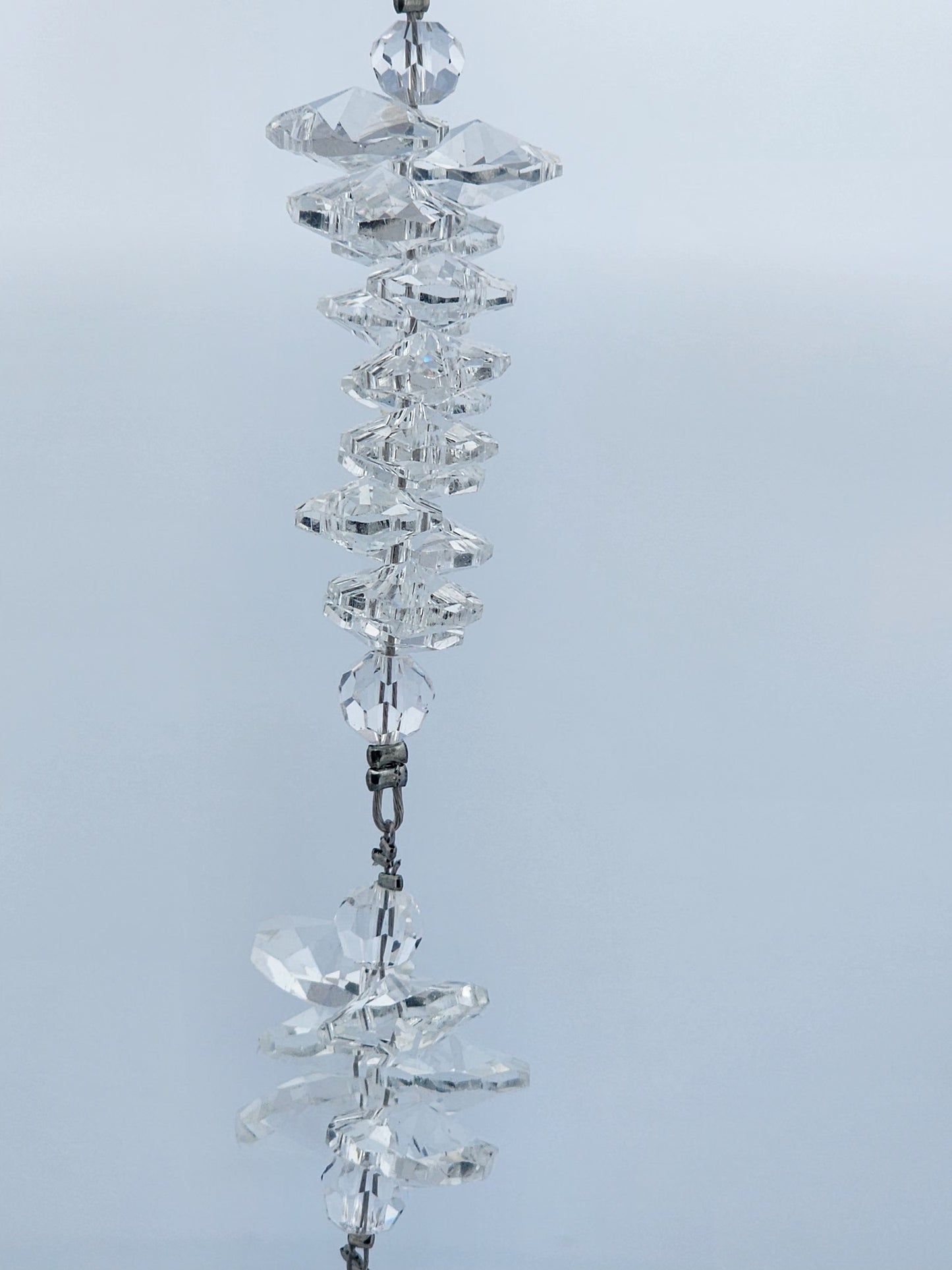 Crystal decorative hanging ornament on a light gray background