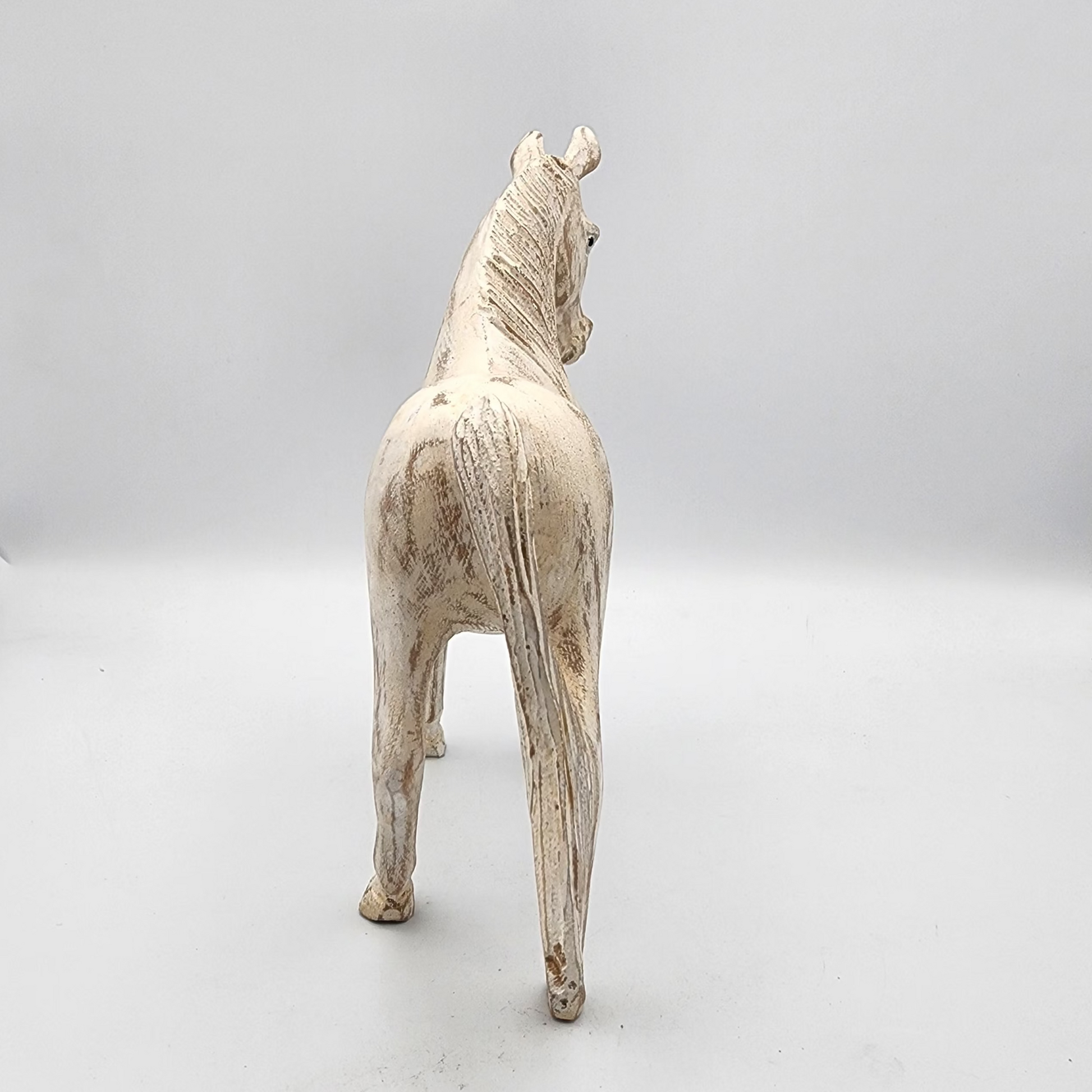 White horse figurine on a white background