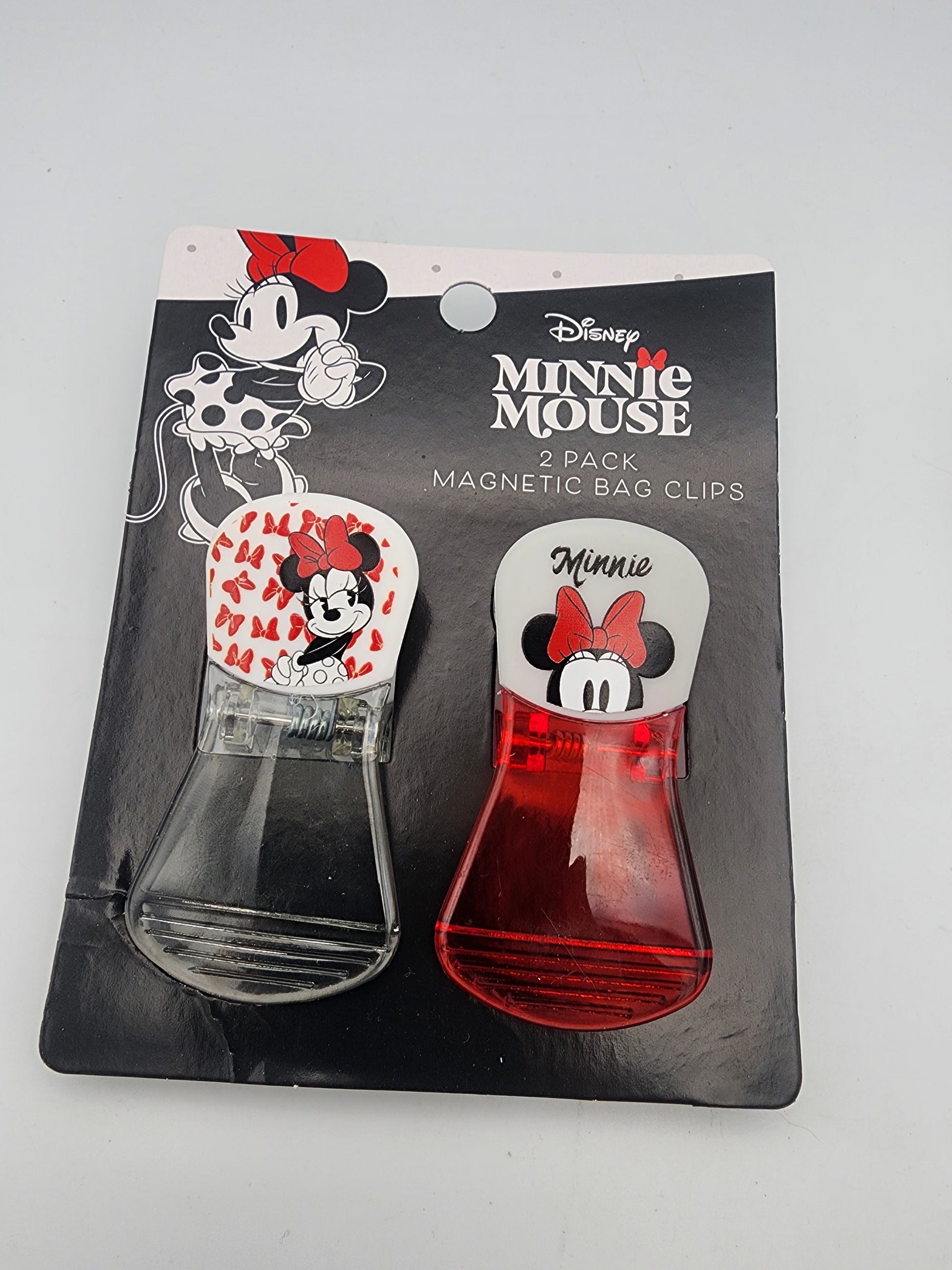 Two Minnie Mouse magnetic bag clips in packaging on a gray background