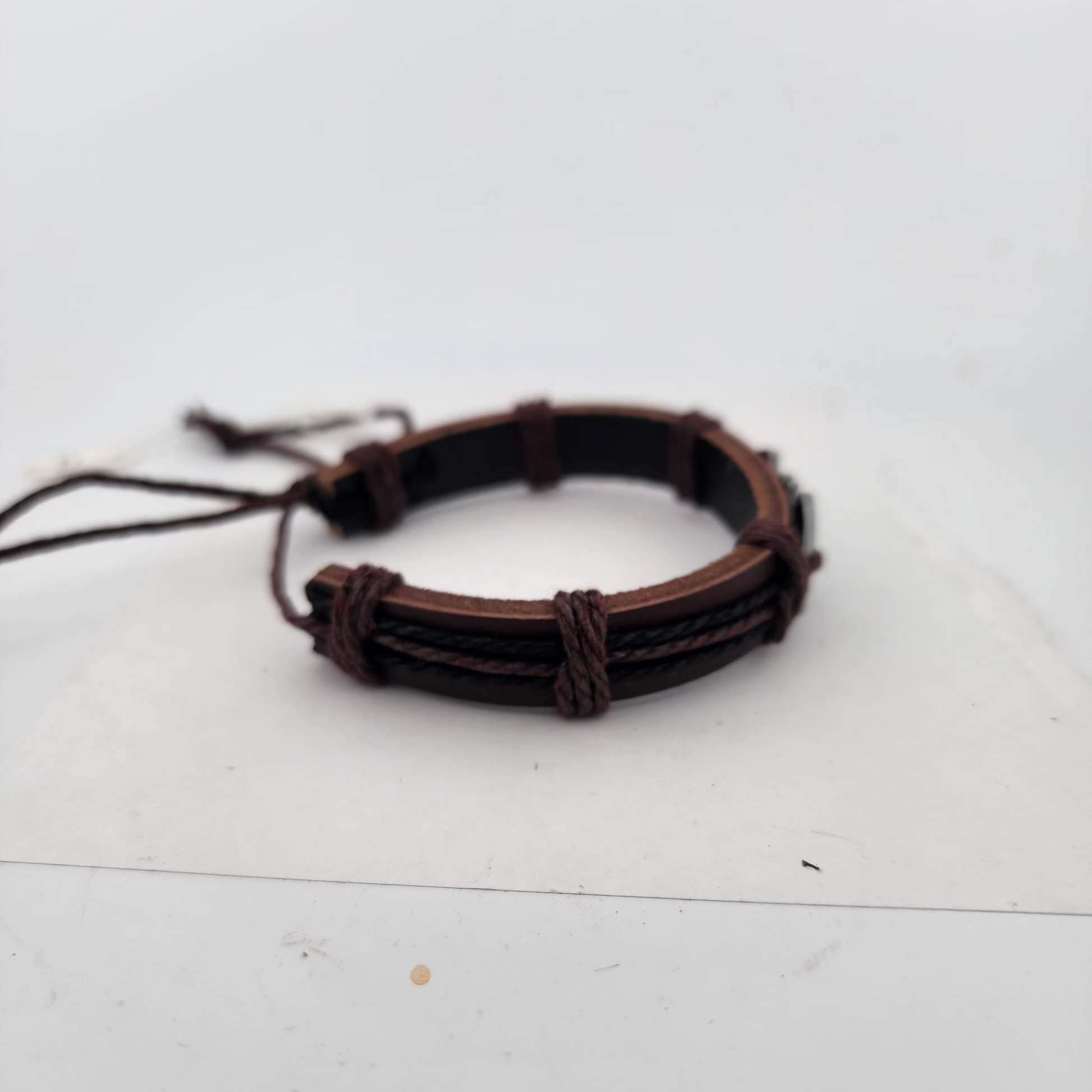 Brown braided bracelet on a white surface