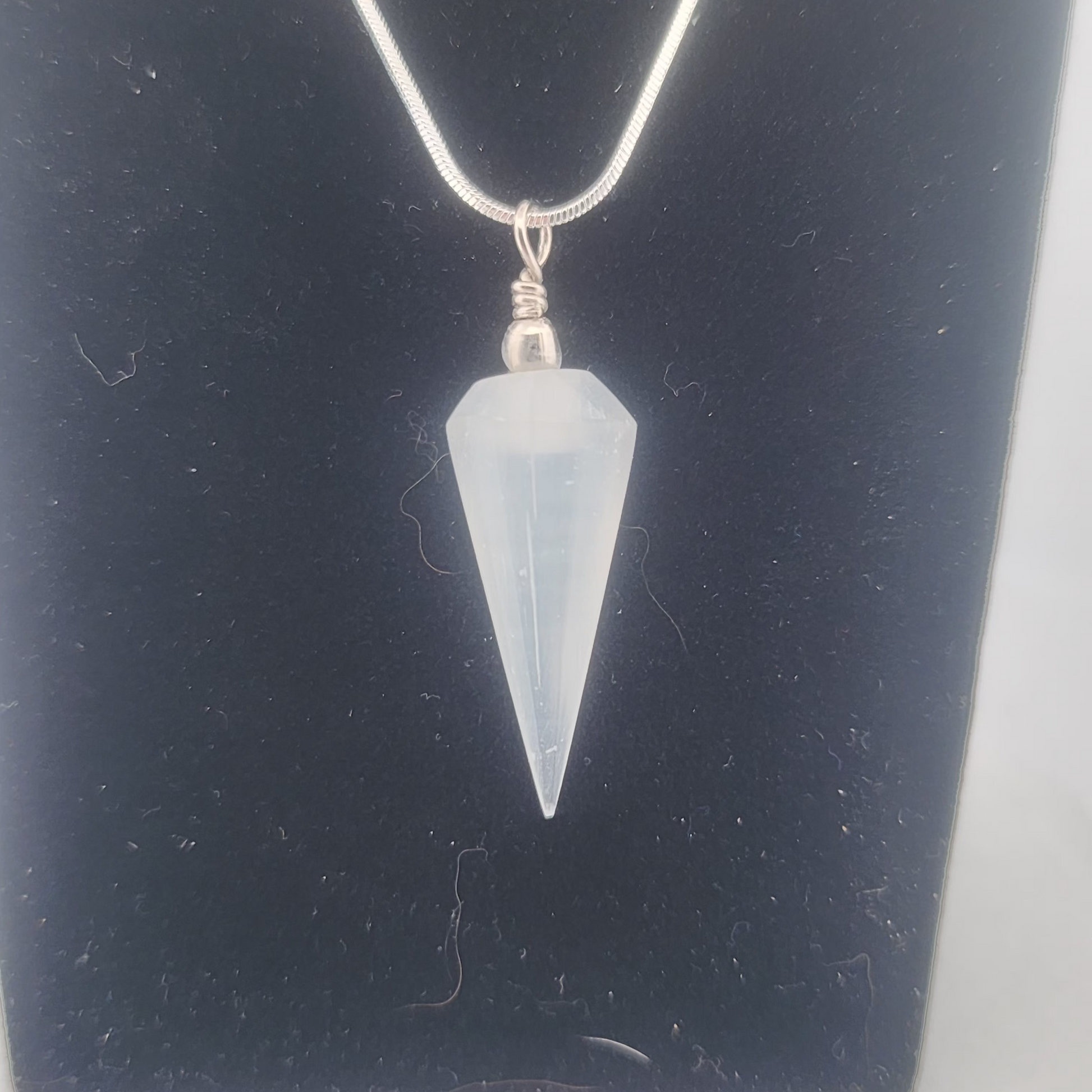 Crystal pendant necklace on a dark background