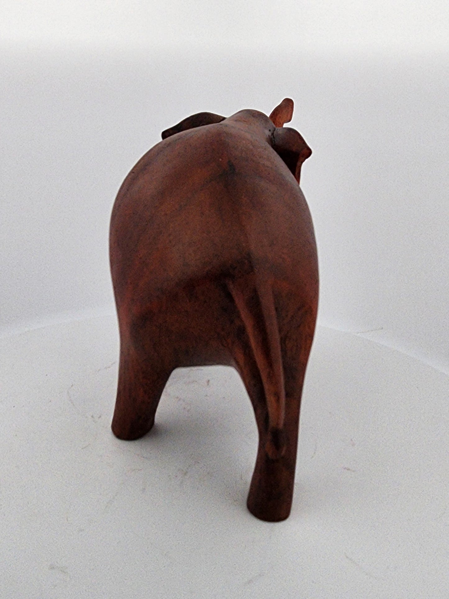 Wooden bull sculpture on a white background