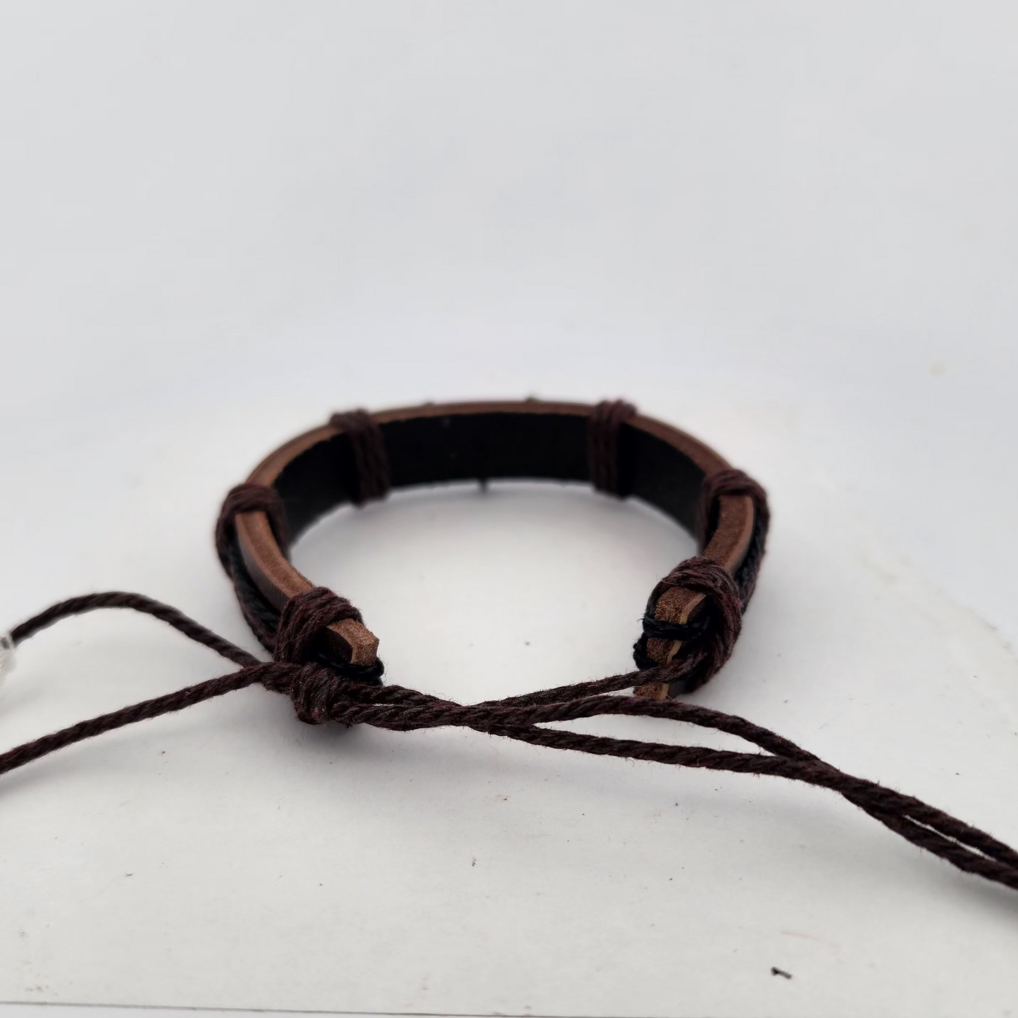 Brown leather bracelet on a white surface