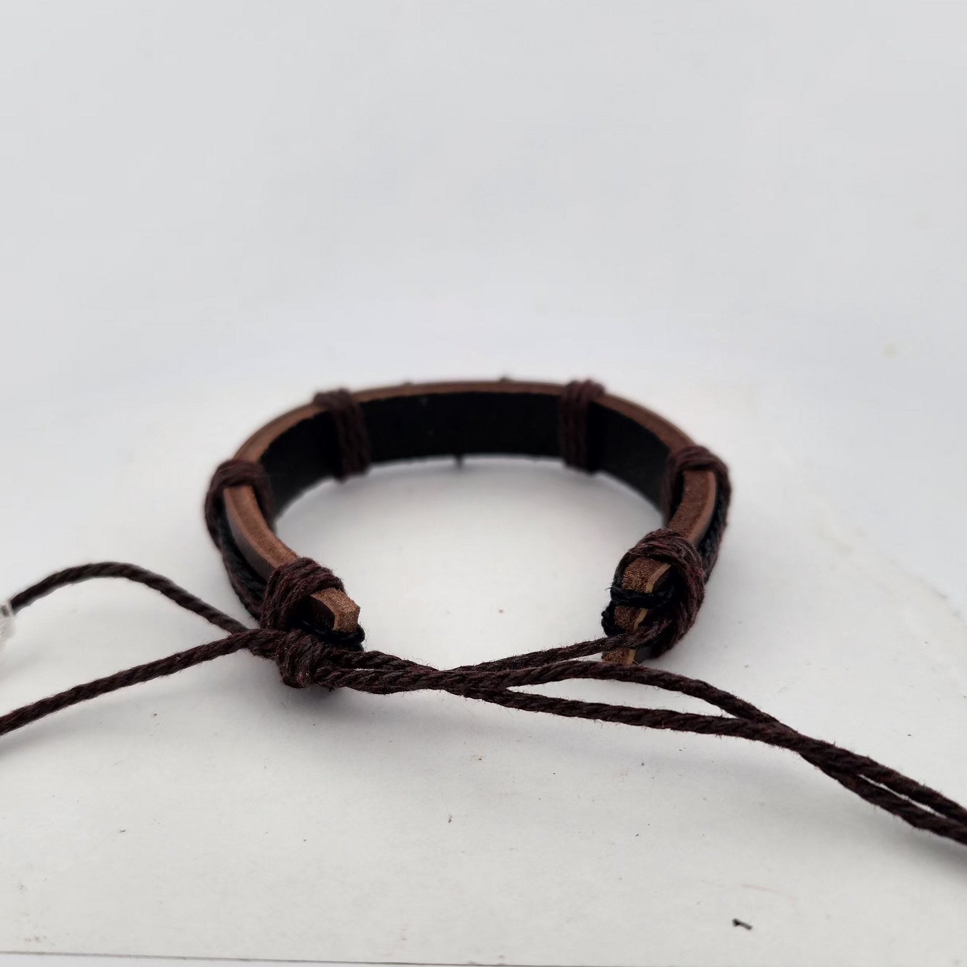 Brown leather bracelet on a white surface