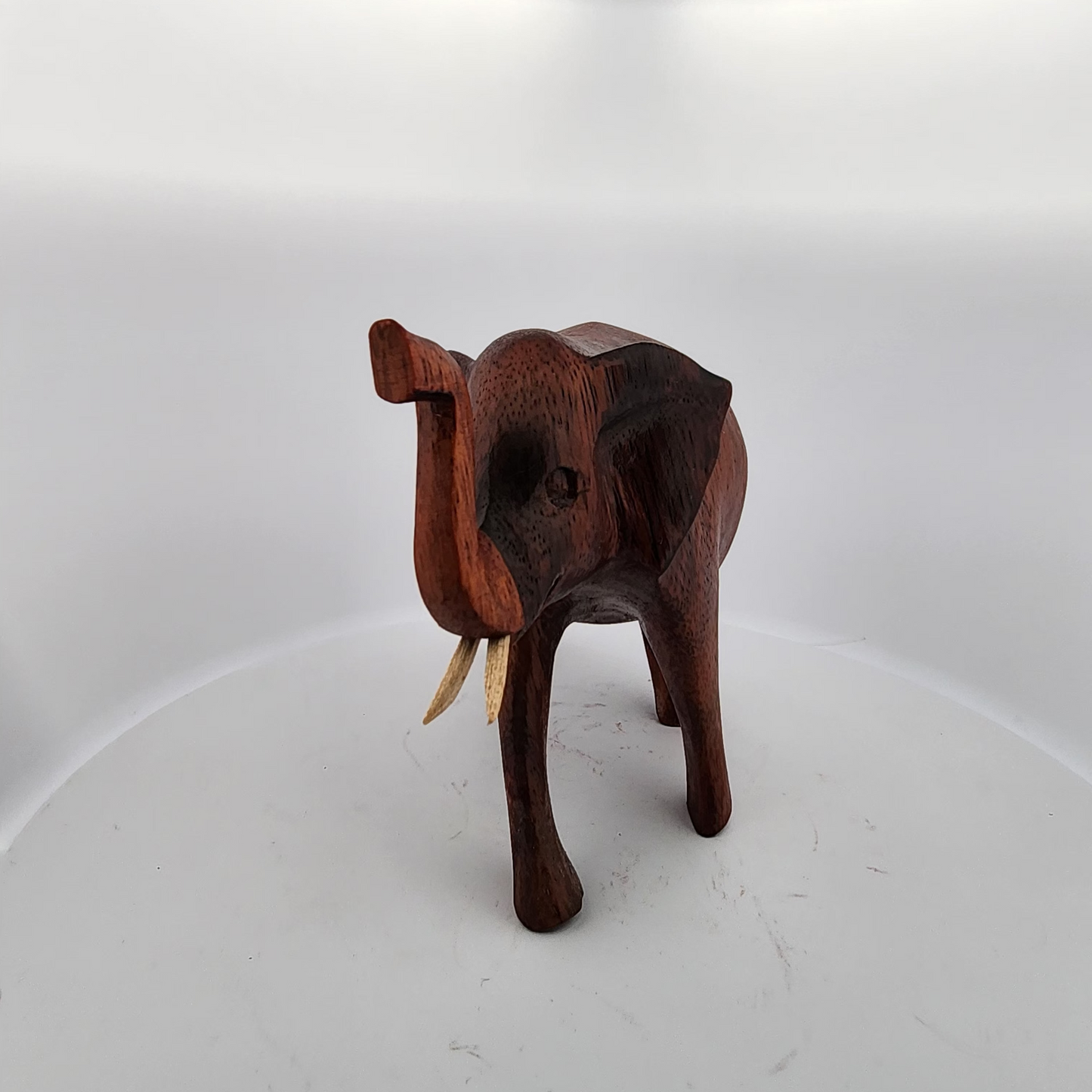 Wooden elephant figurine on a white background