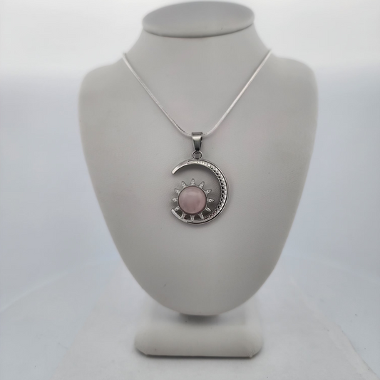 Necklace with a pink pendant on a mannequin bust against a white background