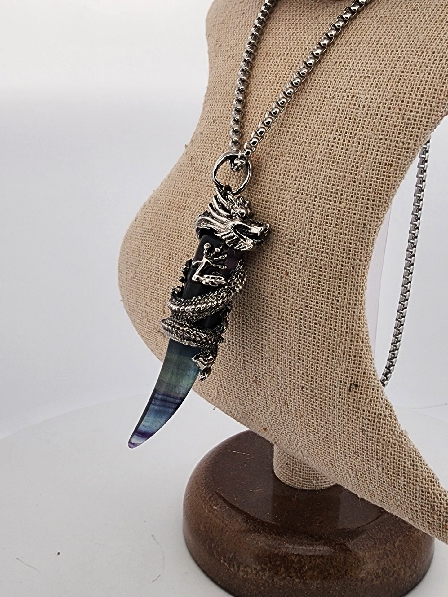 Necklace with a unique pendant on a mannequin bust against a white background