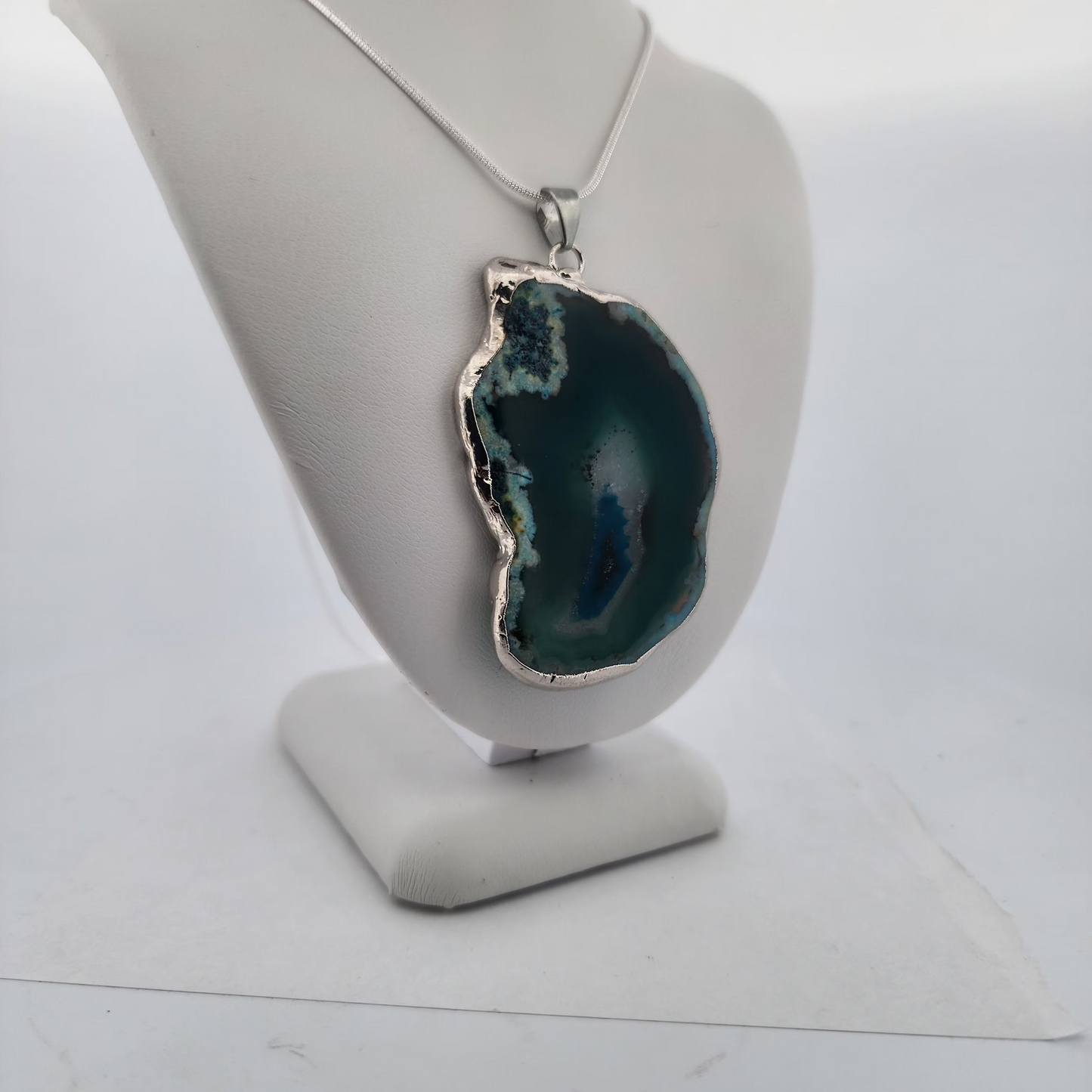 Geode pendant necklace on a white mannequin bust