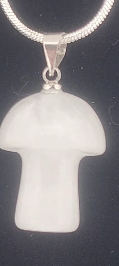 White mushroom-shaped pendant on a black background