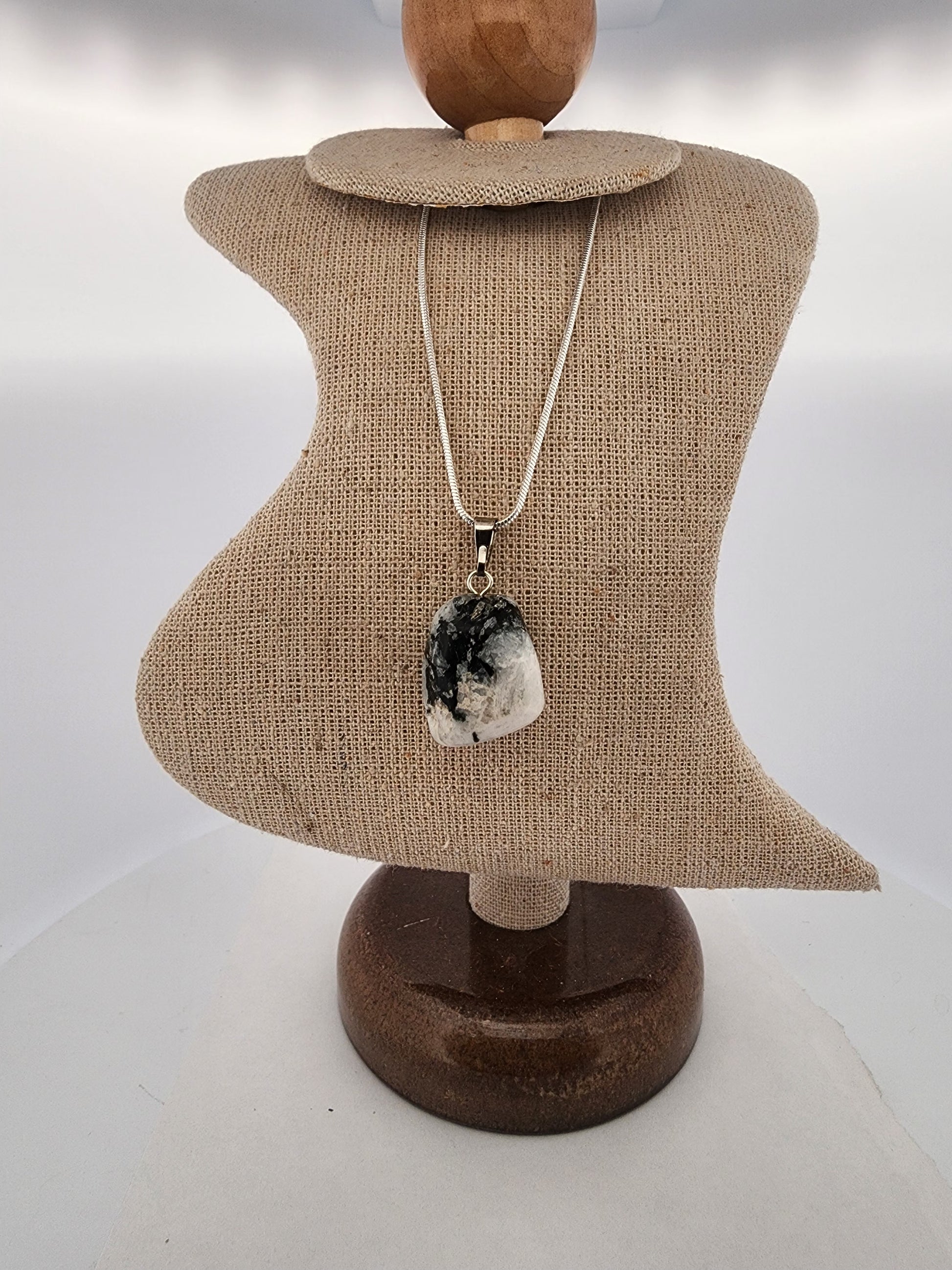Necklace with a pendant on a mannequin bust against a white background